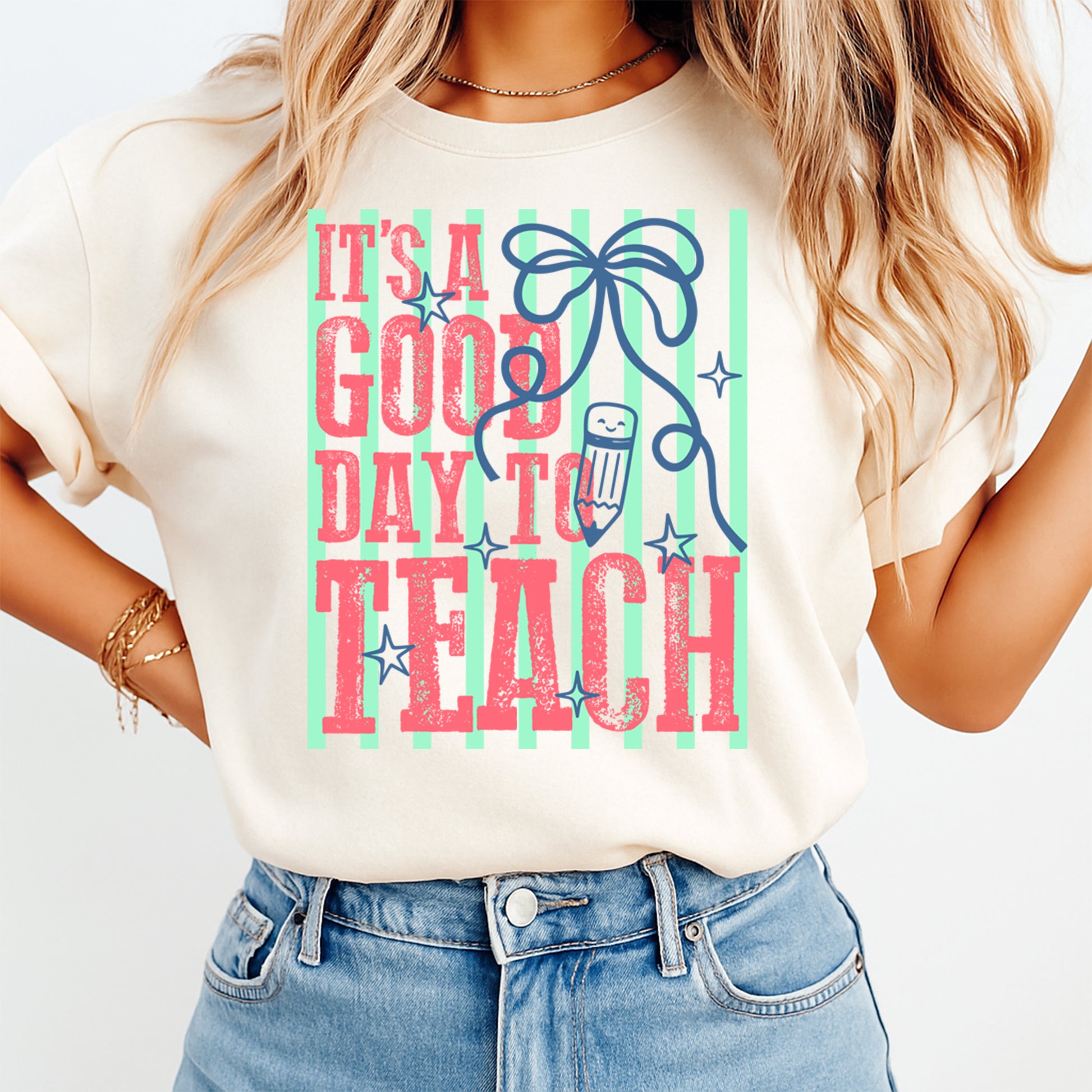 Teacher DTF transfer mockup on cream shirt with It’s a Good Day to Teach pencil bow design