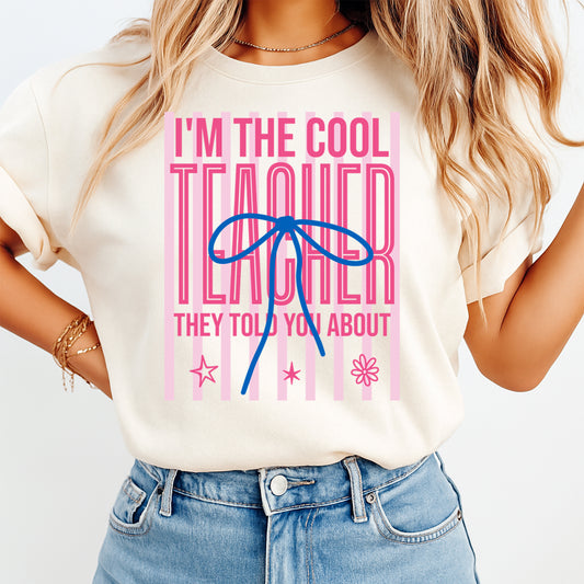 Teacher DTF transfer mockup on cream shirt with I’m the Cool Teacher pink bow design