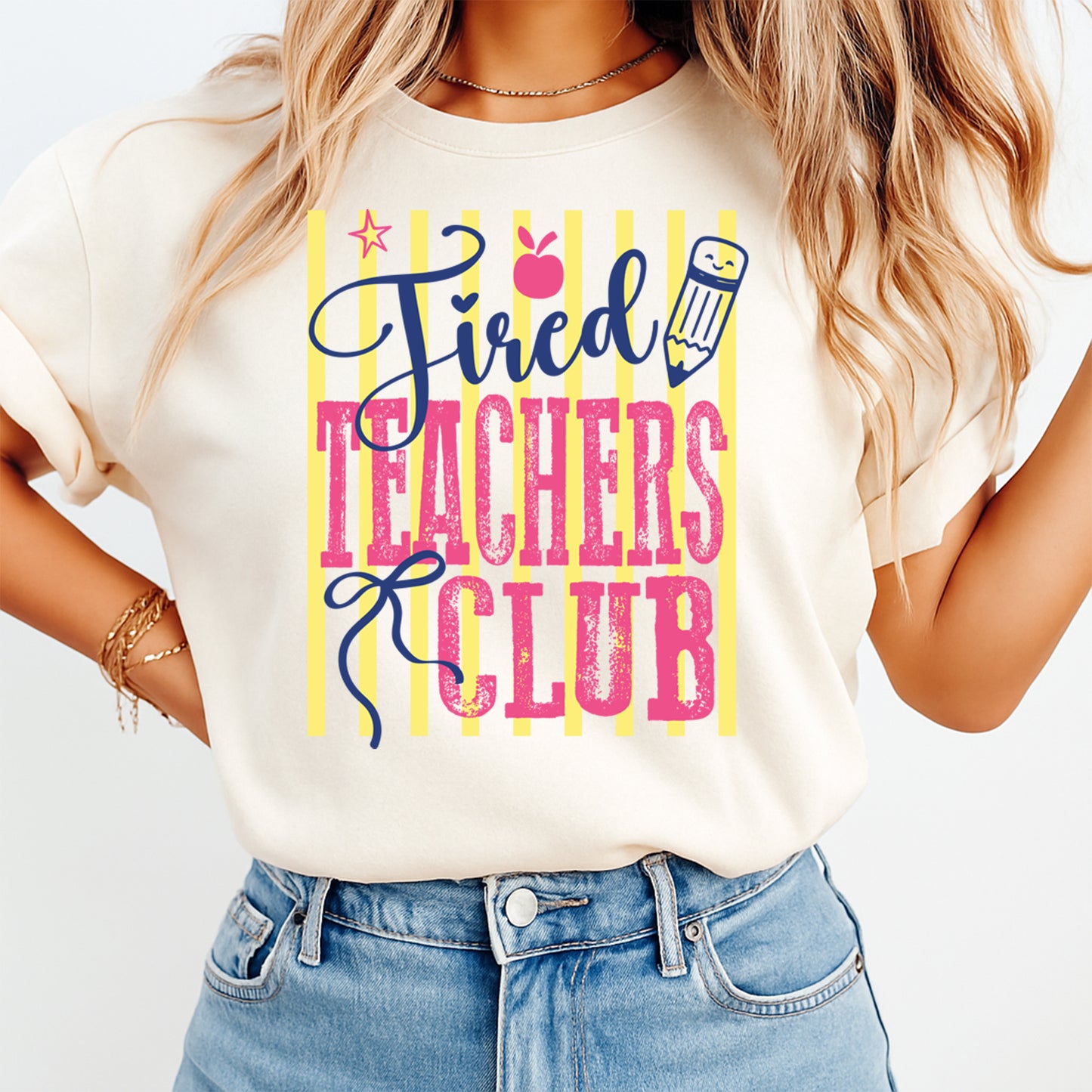 Person wearing a t-shirt with 'Tired Teachers Club' text and graphics.