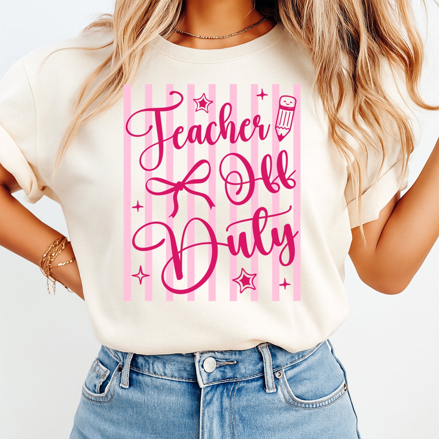 Teacher Off Duty DTF transfer mockup on cream shirt with pink bow pencil and stripe design