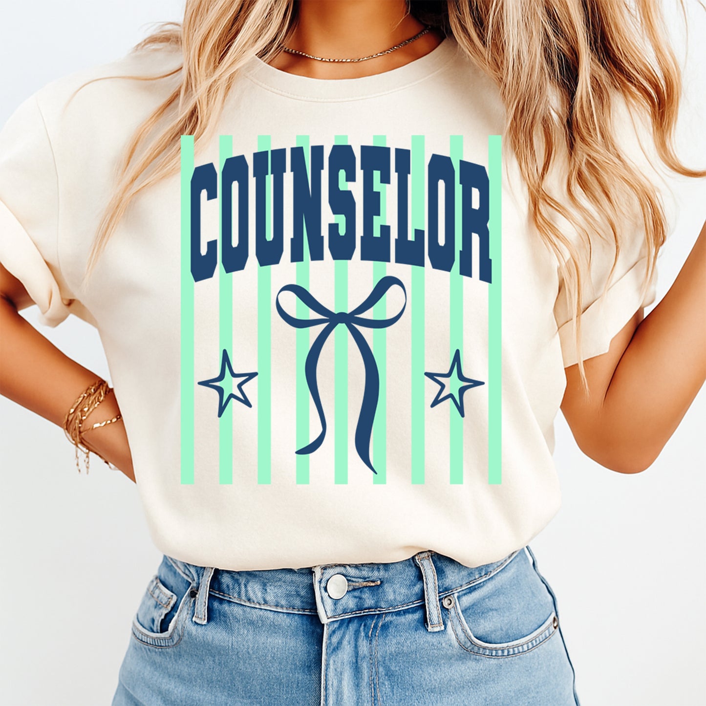 Person wearing a t-shirt with 'Counselor' and decorative elements on a plain background