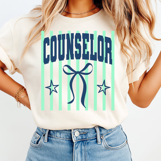 Person wearing a t-shirt with 'Counselor' and decorative elements on a plain background