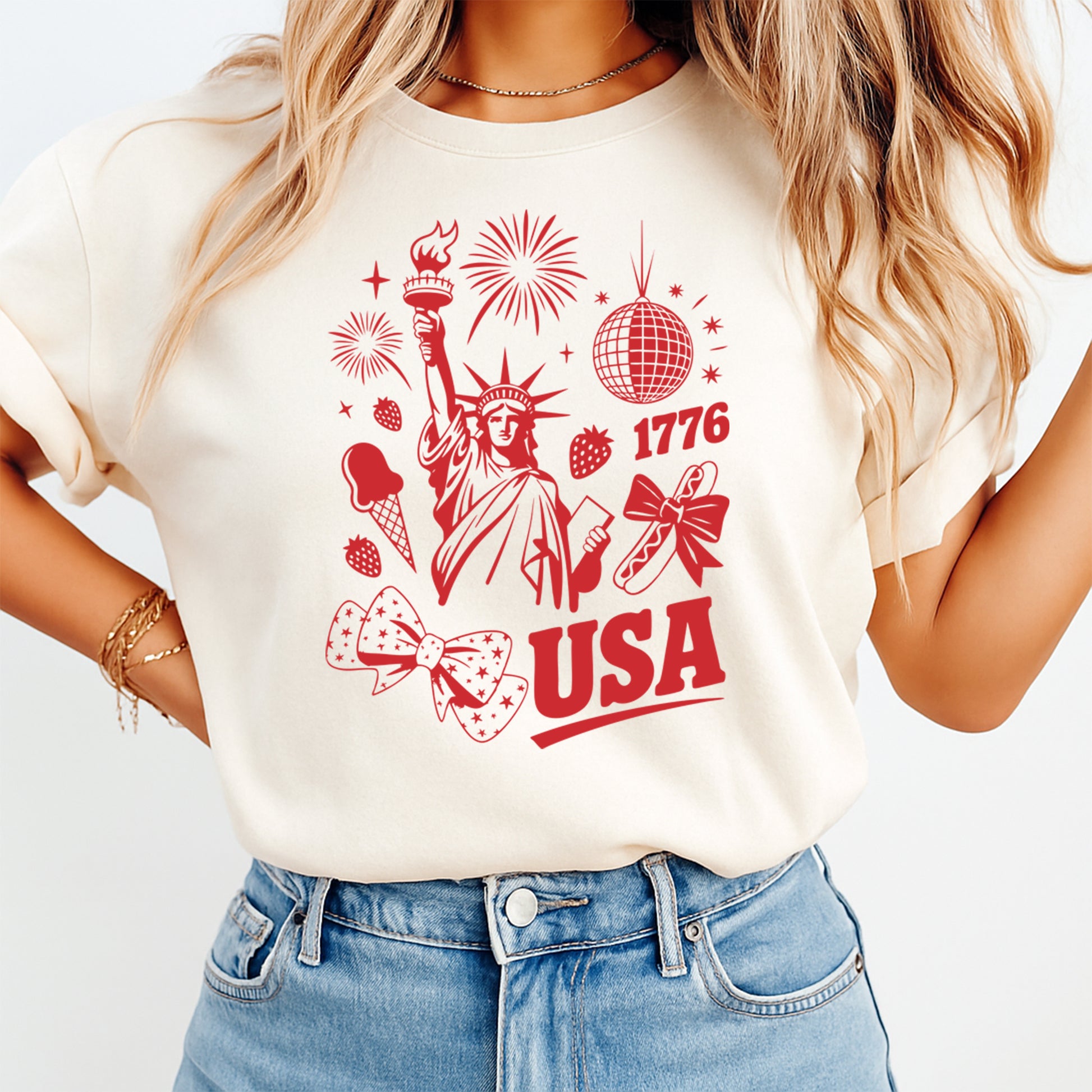 Woman wearing cream shirt with red USA patriotic DTF transfer featuring Lady Liberty fireworks and bows
