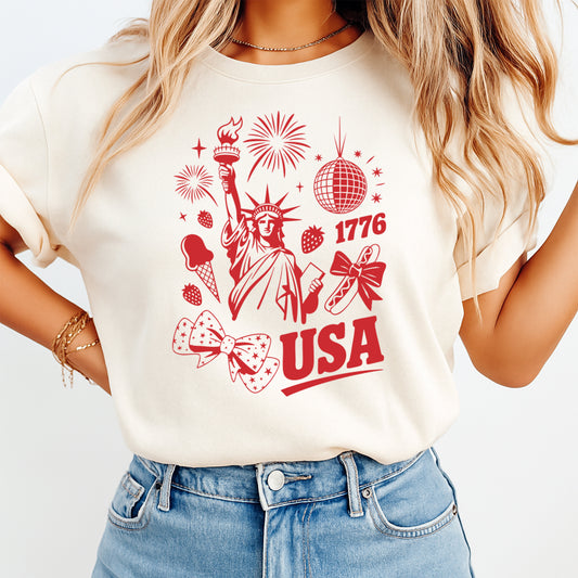 Woman wearing cream shirt with red USA patriotic DTF transfer featuring Lady Liberty fireworks and bows