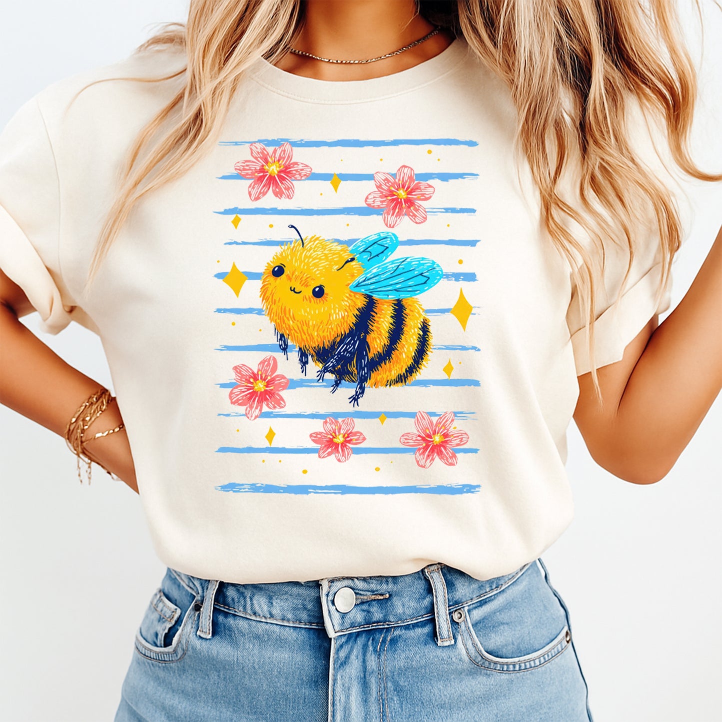 Person wearing a white t-shirt with a colorful bee design and flowers.