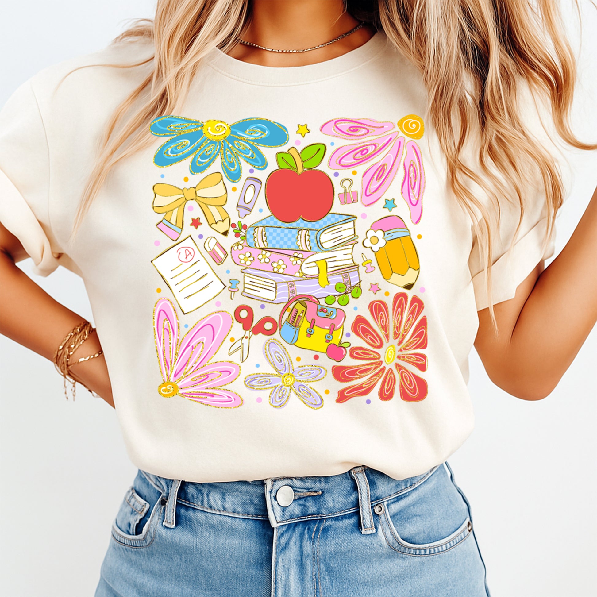 Person wearing a white t-shirt with colorful graphics on a plain background