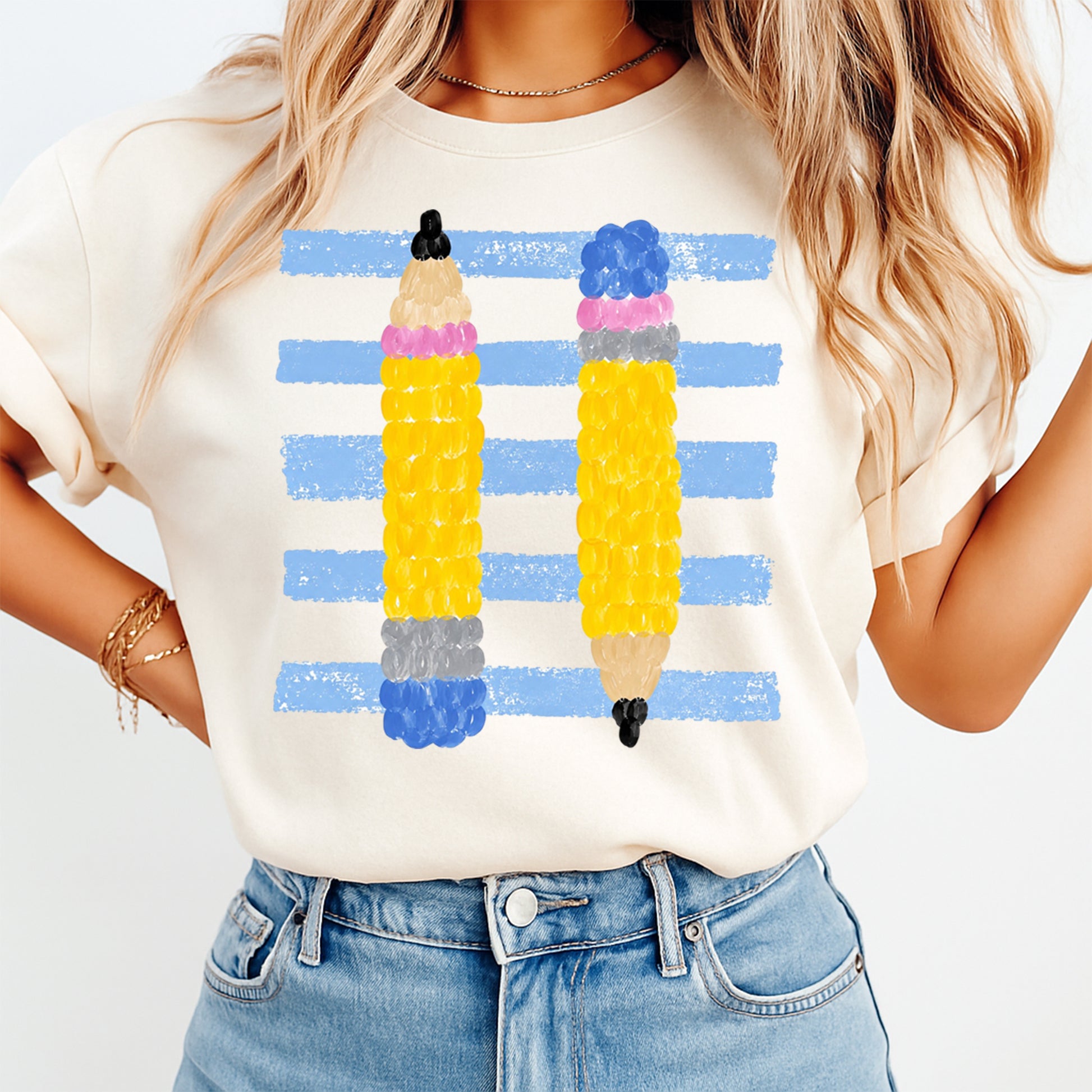 Person wearing a t-shirt with colorful pencil design on a white background