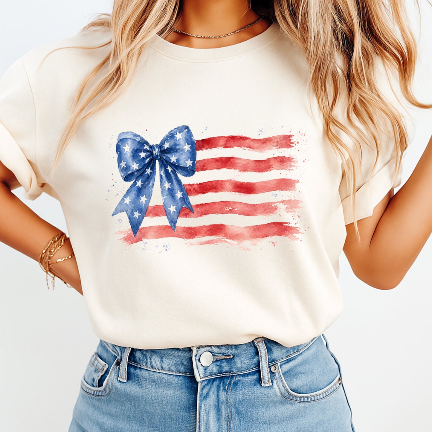 Woman wearing cream shirt with Fourth of July patriotic flag bow DTF transfer featuring watercolor red stripes and blue star bow