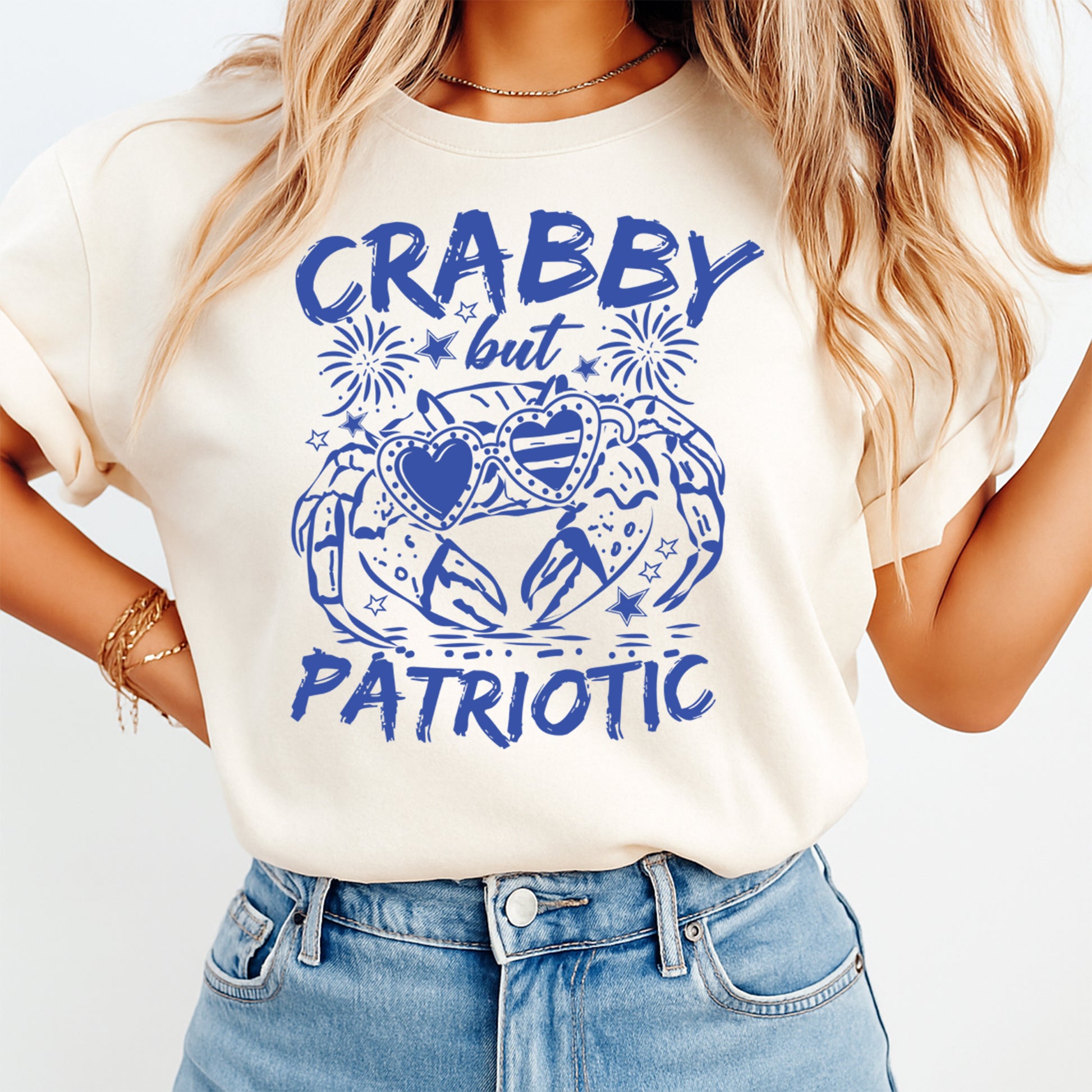 Person wearing a white t-shirt with blue graphic and text 'CRABBY but PATRIOTIC' on a light background