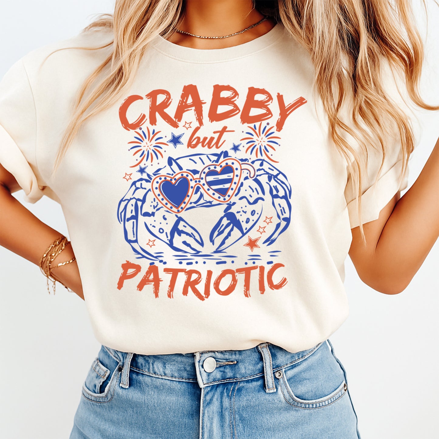 Person wearing a white t-shirt with 'CRABBY but PATRIOTIC' text and graphic design.