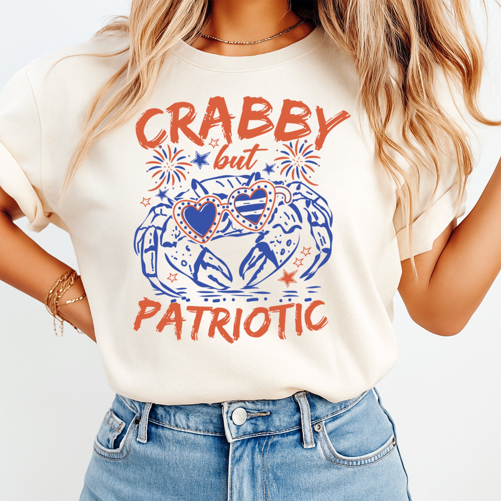 Person wearing a white t-shirt with 'CRABBY but PATRIOTIC' text and graphic design.
