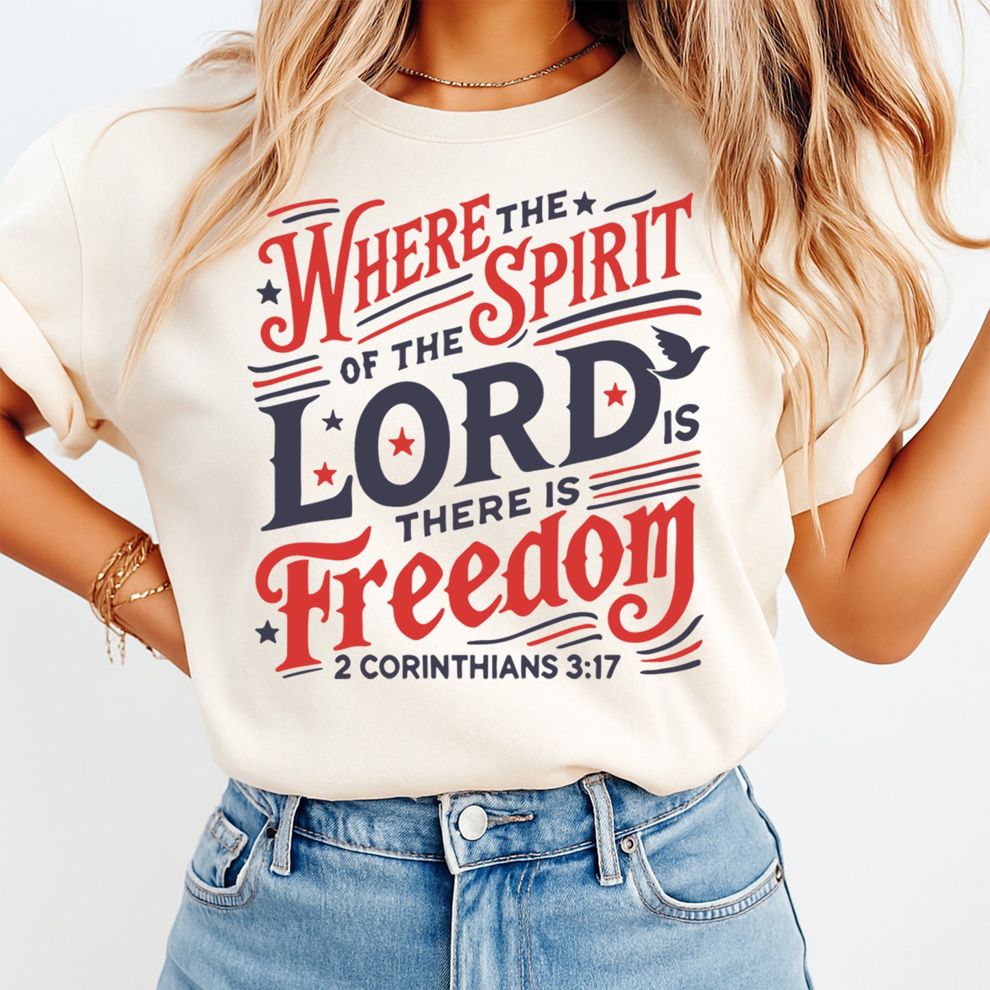 Woman wearing cream shirt with Fourth of July Where the Spirit of the Lord DTF transfer featuring red white and blue scripture design