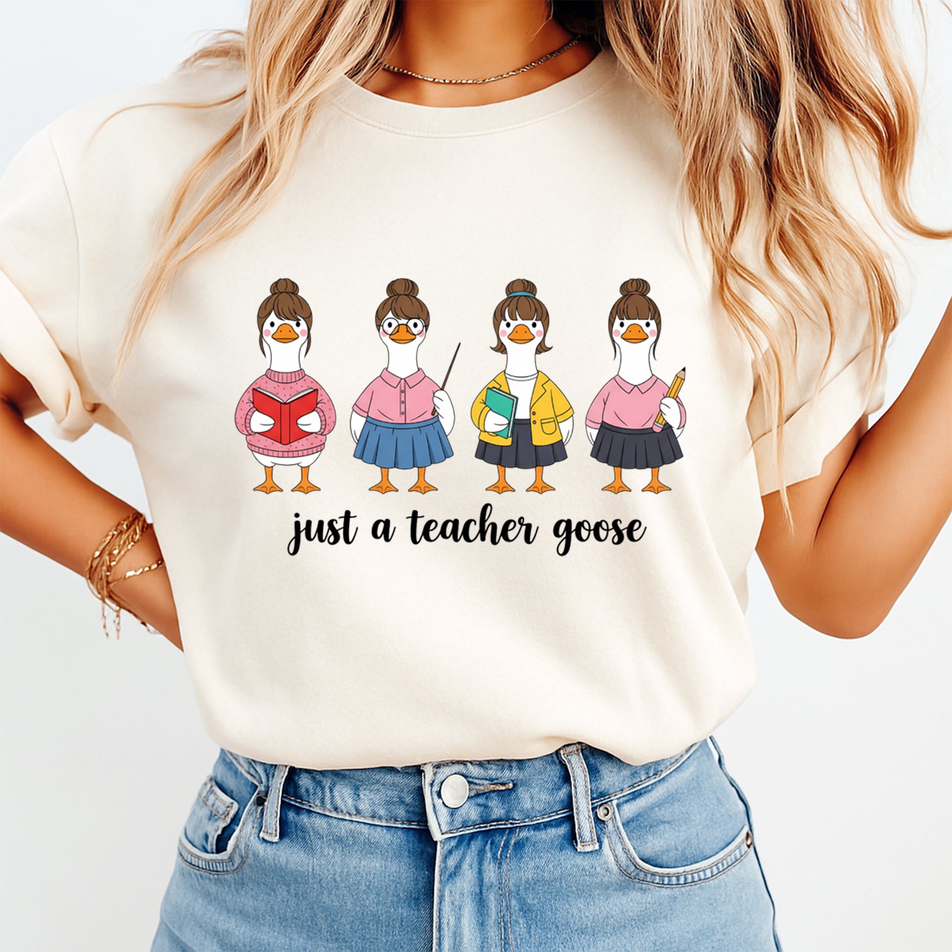 Person wearing a t-shirt with cartoon geese and 'just a teacher goose' text.