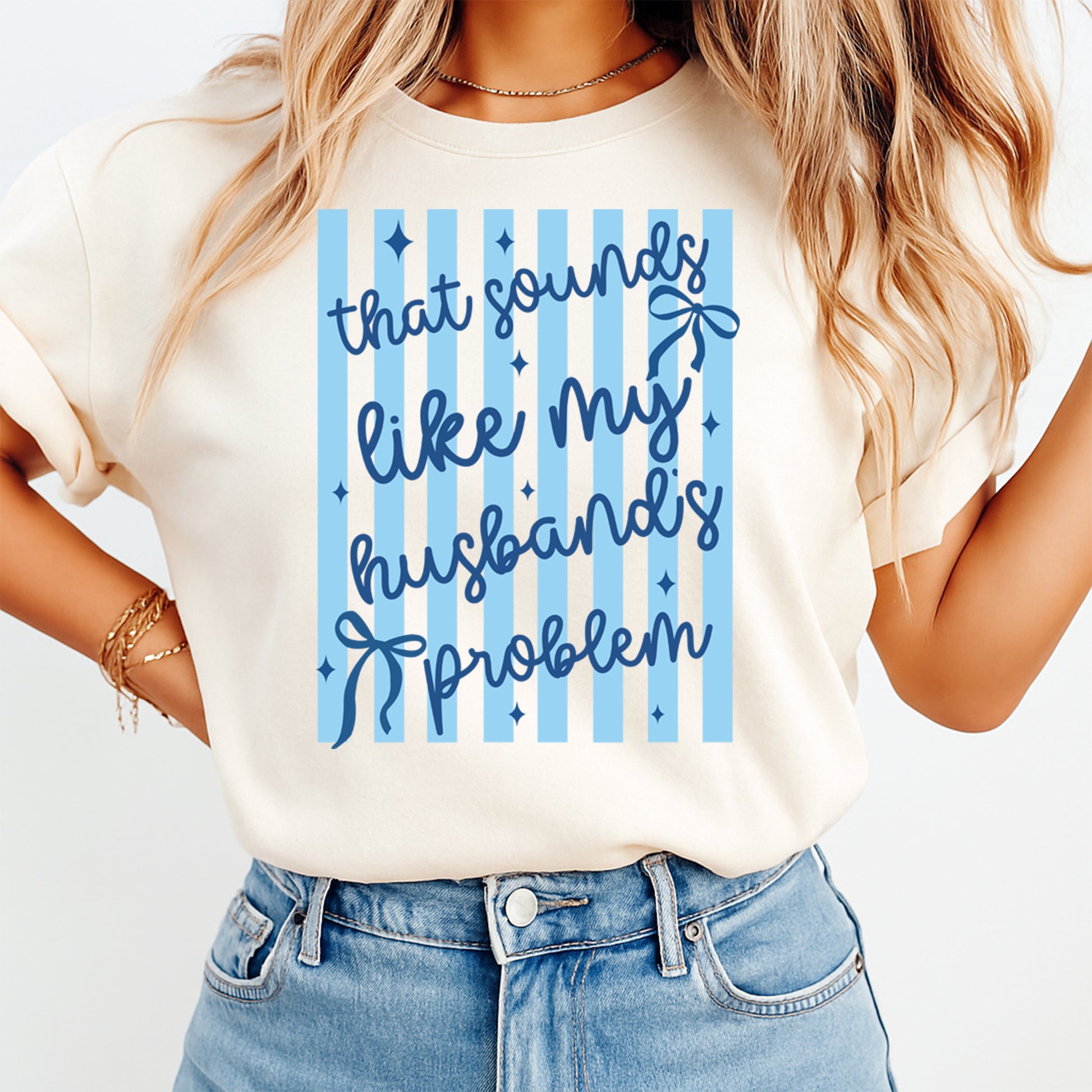 Person wearing a white t-shirt with blue text and graphics on a light background