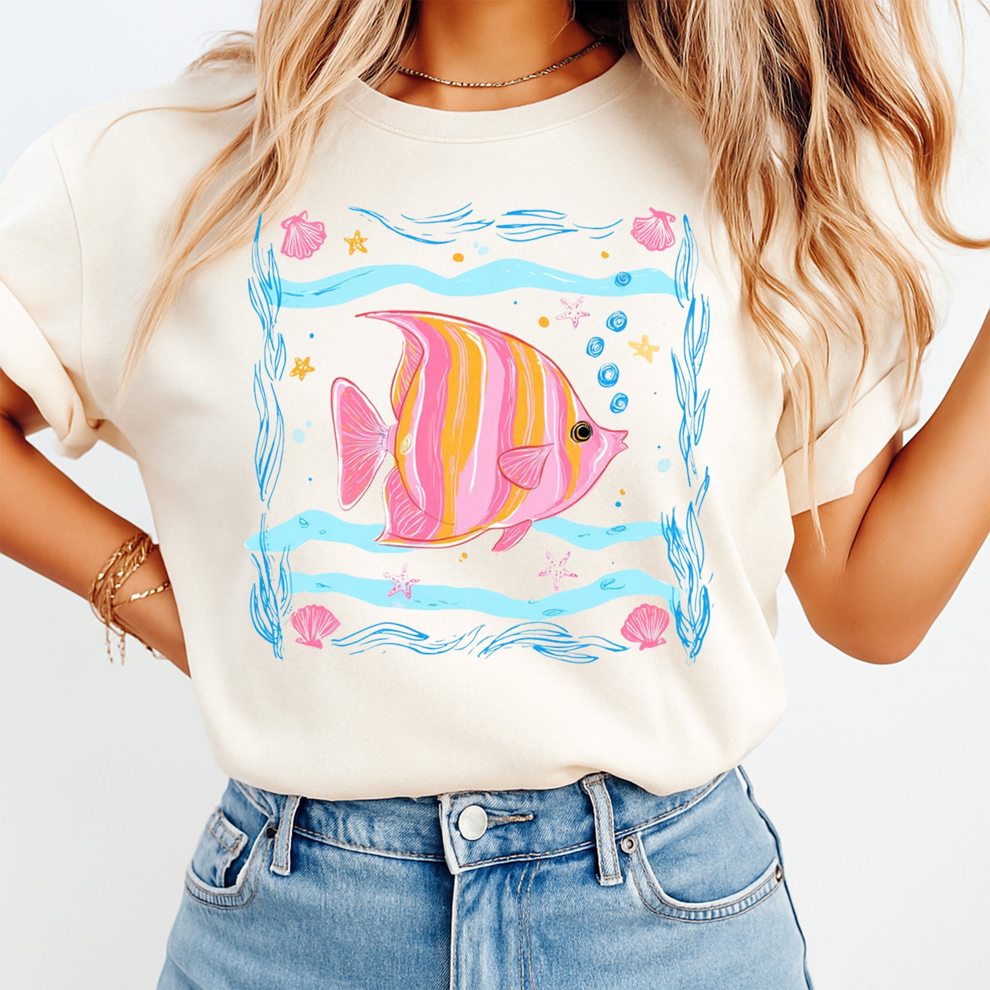 Person wearing a white t-shirt with a colorful fish design on a plain background