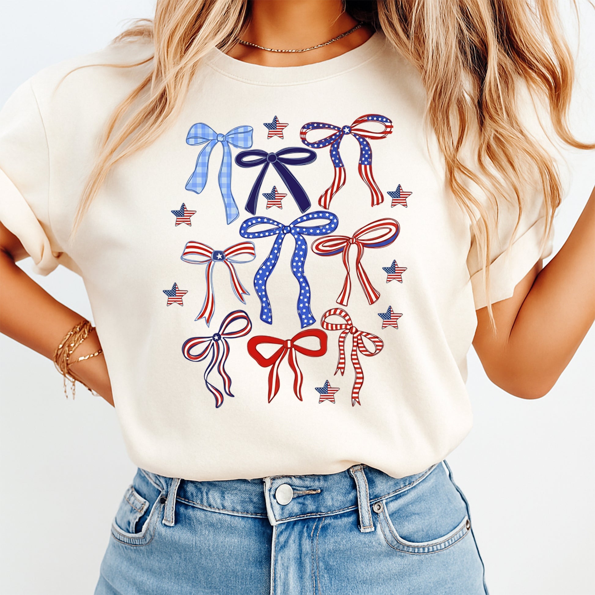 Woman wearing cream shirt with Fourth of July patriotic bows DTF transfer featuring red white and blue ribbon designs