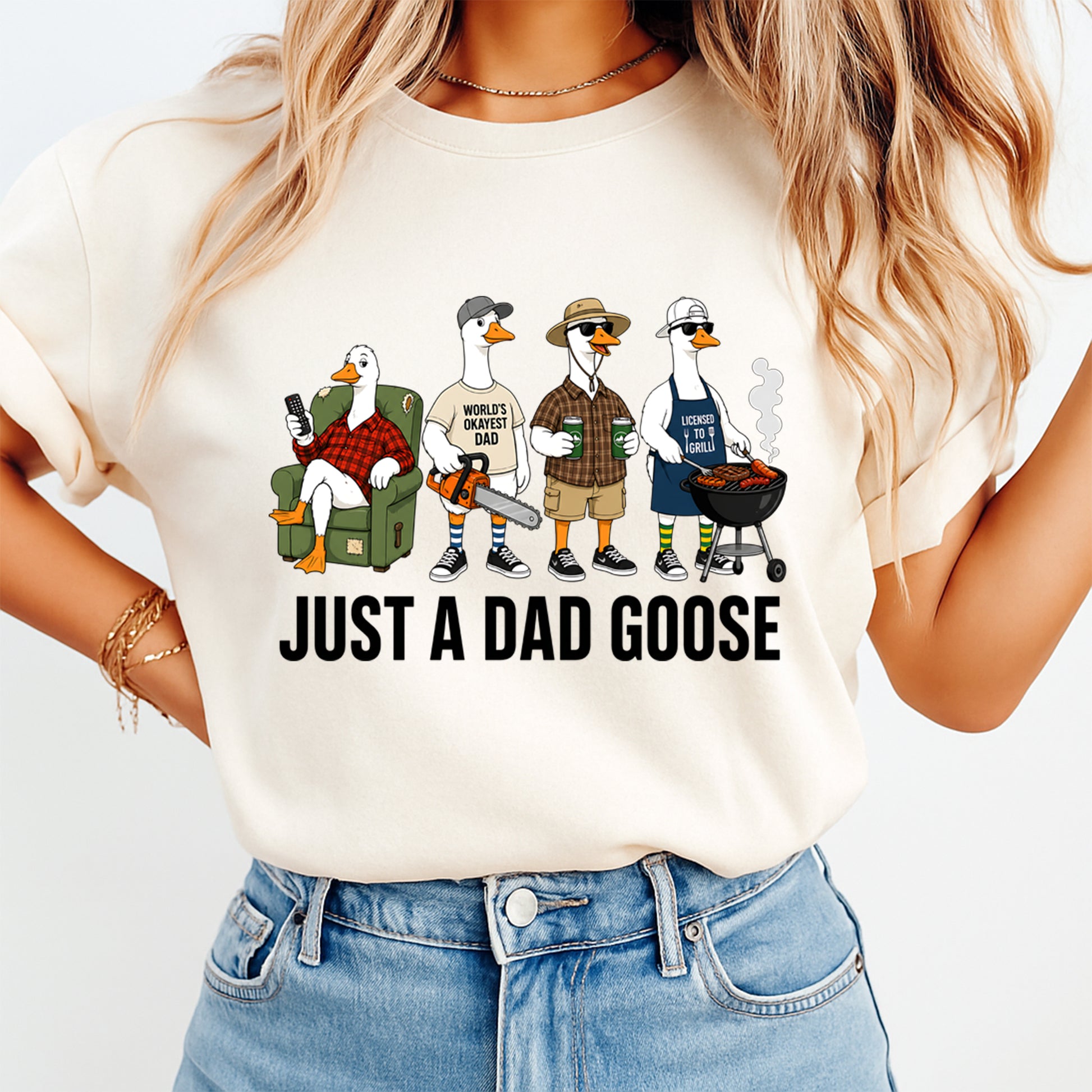 Person wearing a t-shirt with cartoon ducks and 'Just a Dad Goose' text