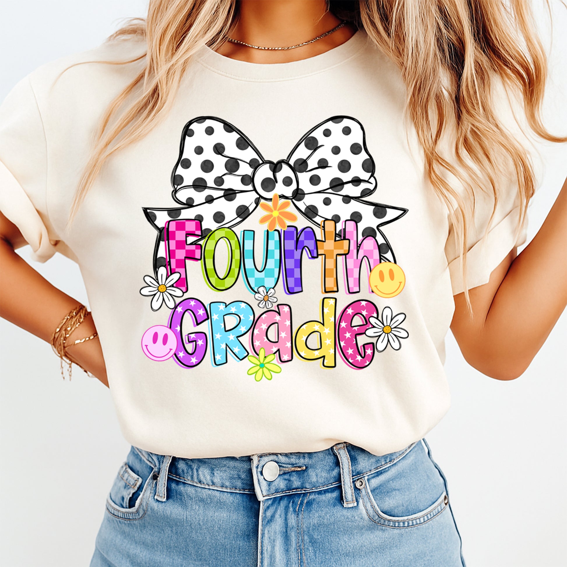 Person wearing a white t-shirt with 'Fourth Grade' design and polka dot bow, standing against a light background.