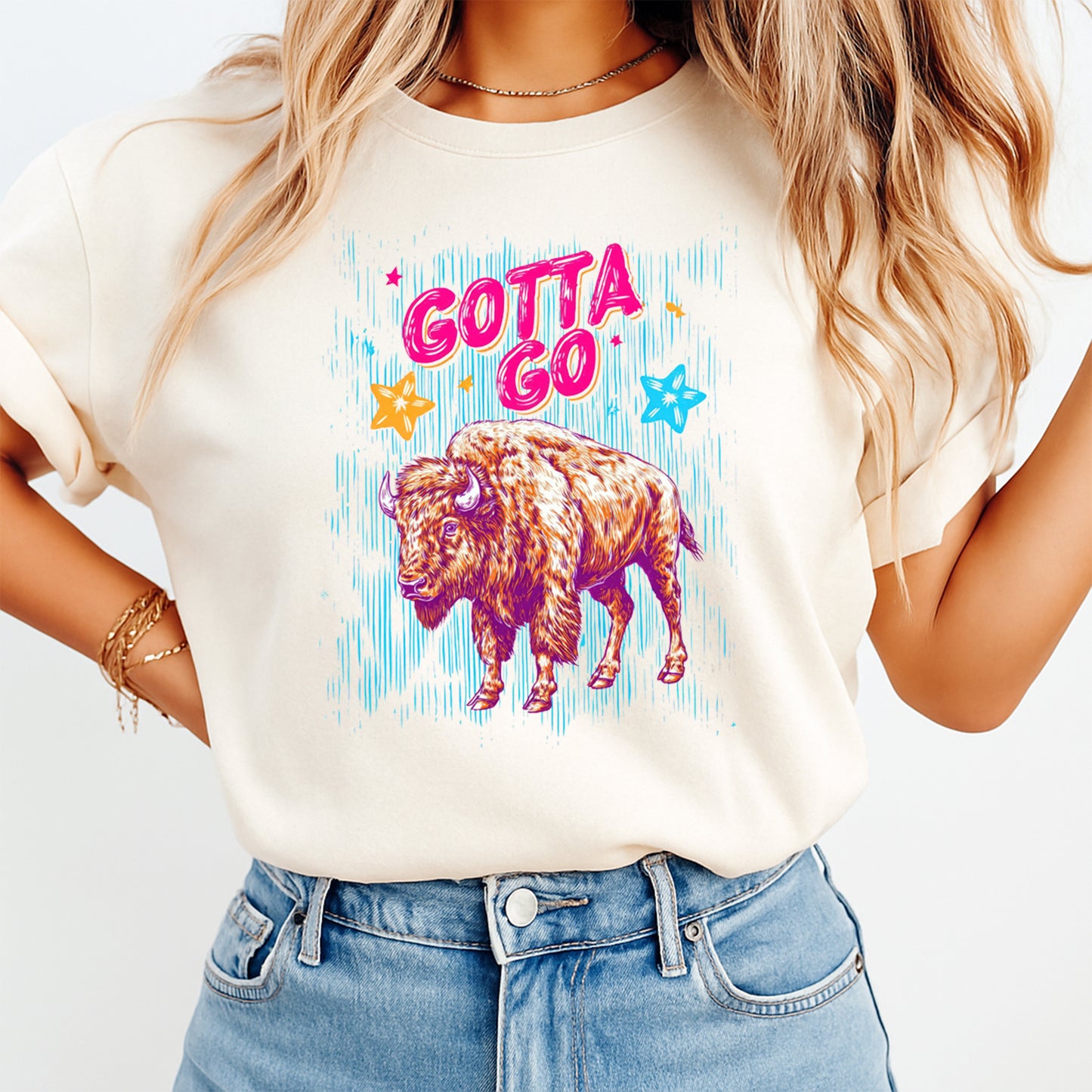 Person wearing a white t-shirt with a colorful bison graphic and 'Gotta Go' text.