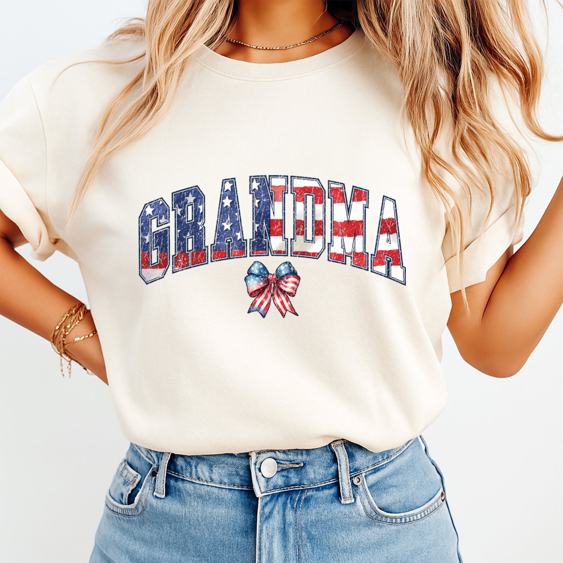 Person wearing a white t-shirt with 'GRANDMA' text and American flag design.