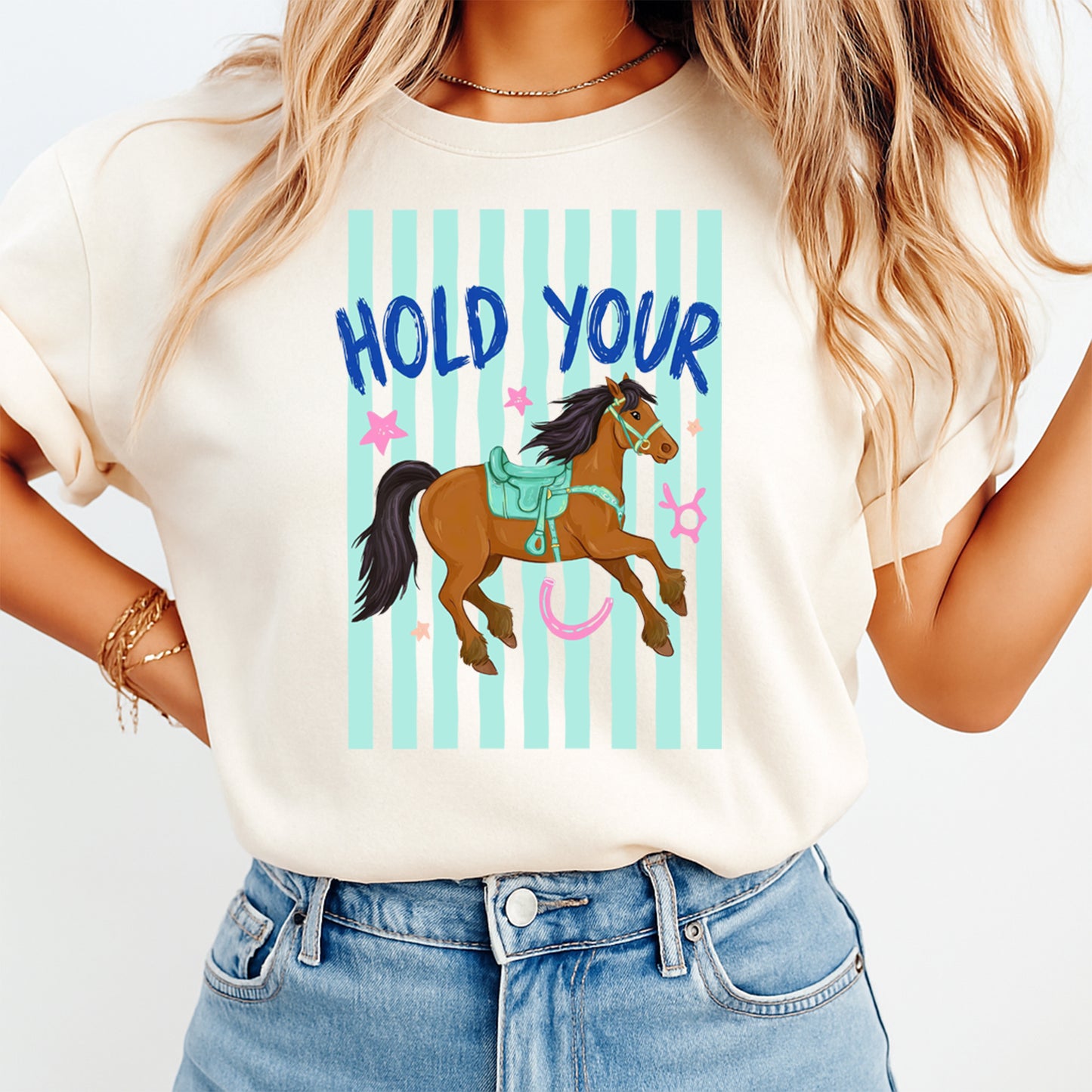 Person wearing a t-shirt with a horse graphic and text 'Hold Your' on a white background