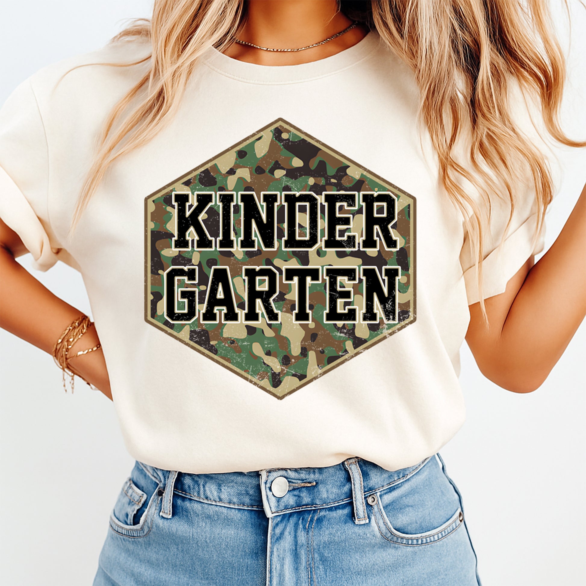 Person wearing a white t-shirt with a camouflage 'KinderGarten' design.