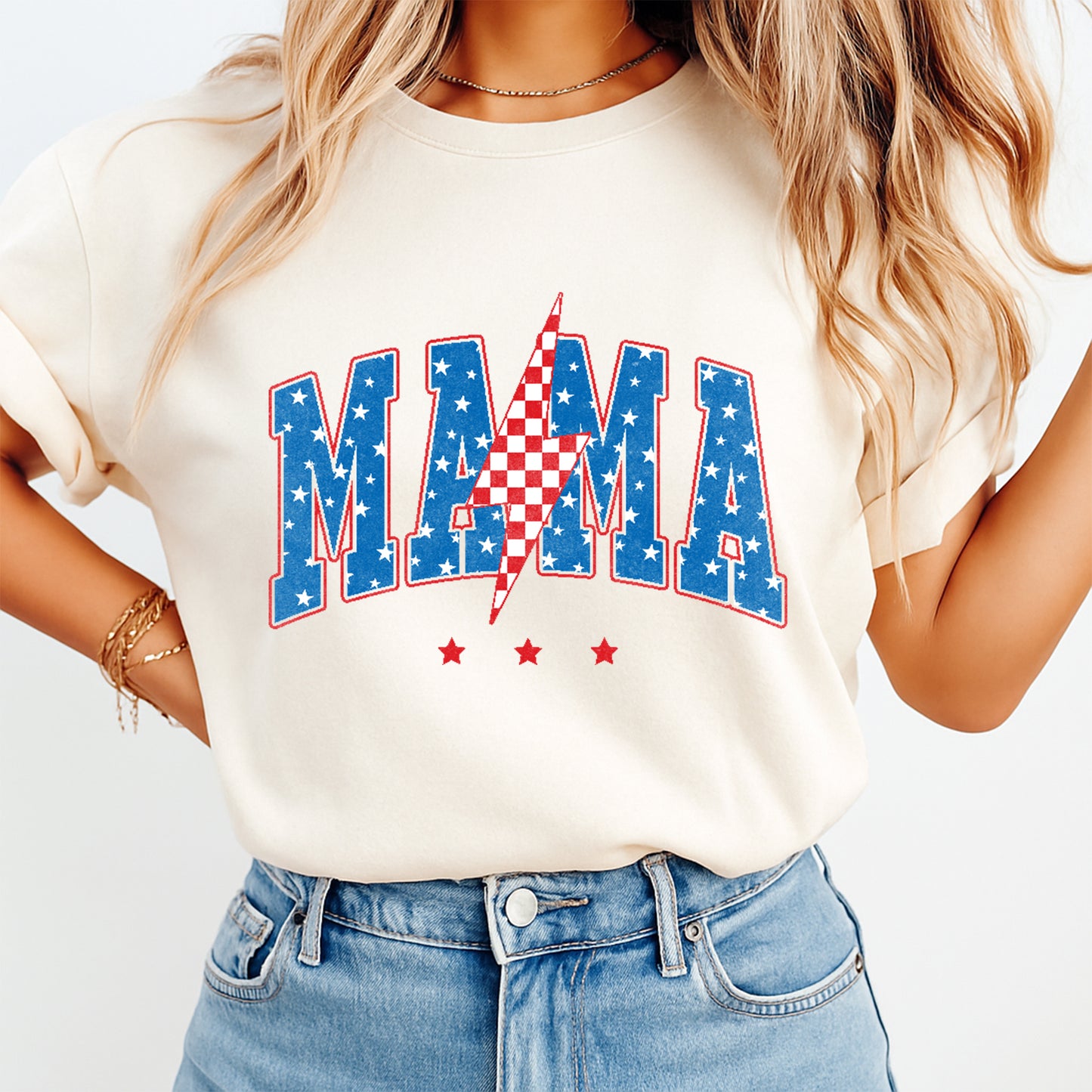 Person wearing a white t-shirt with 'MAMA' printed in red, blue, and white on a plain background