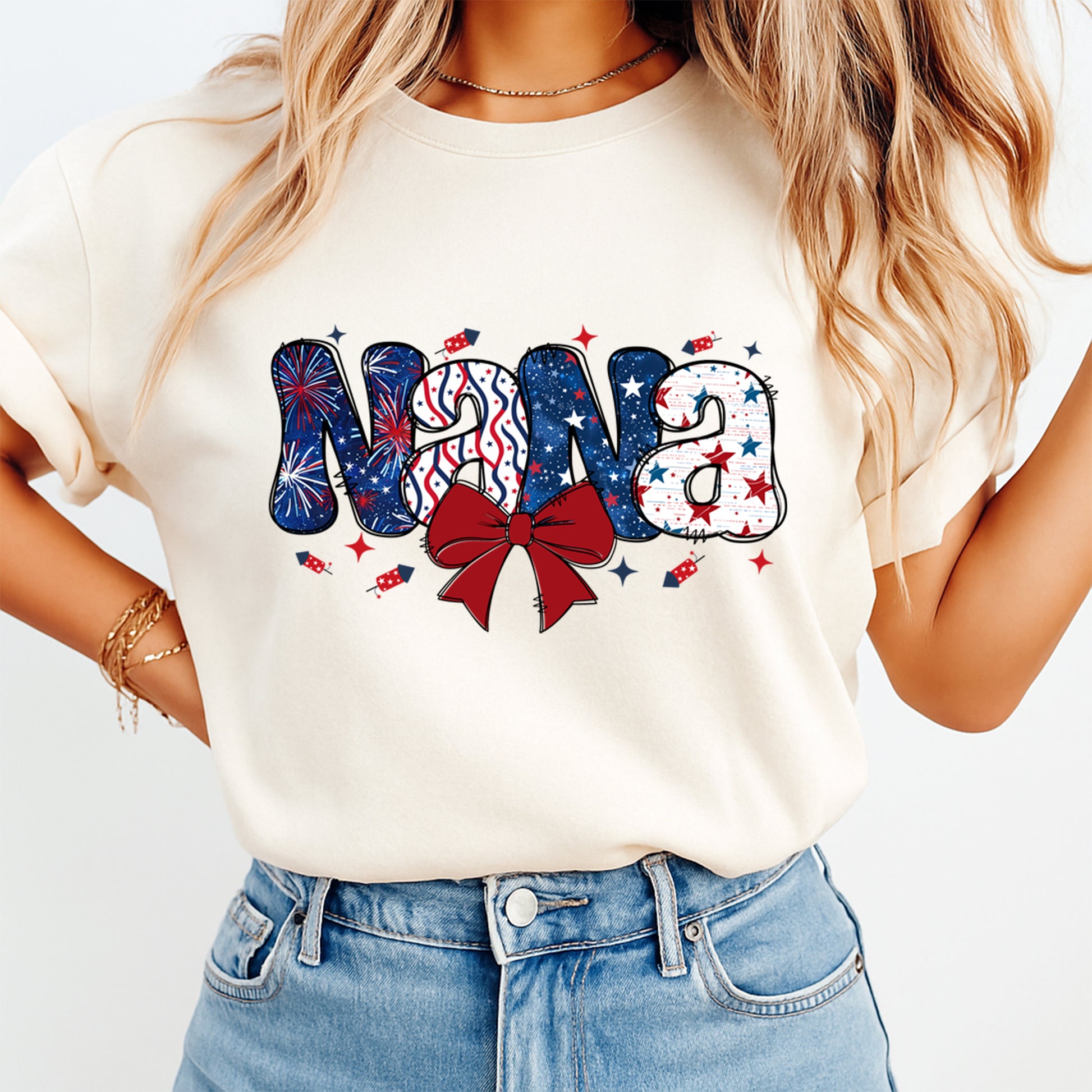 Person wearing a white t-shirt with 'Nana' design in red, white, and blue.