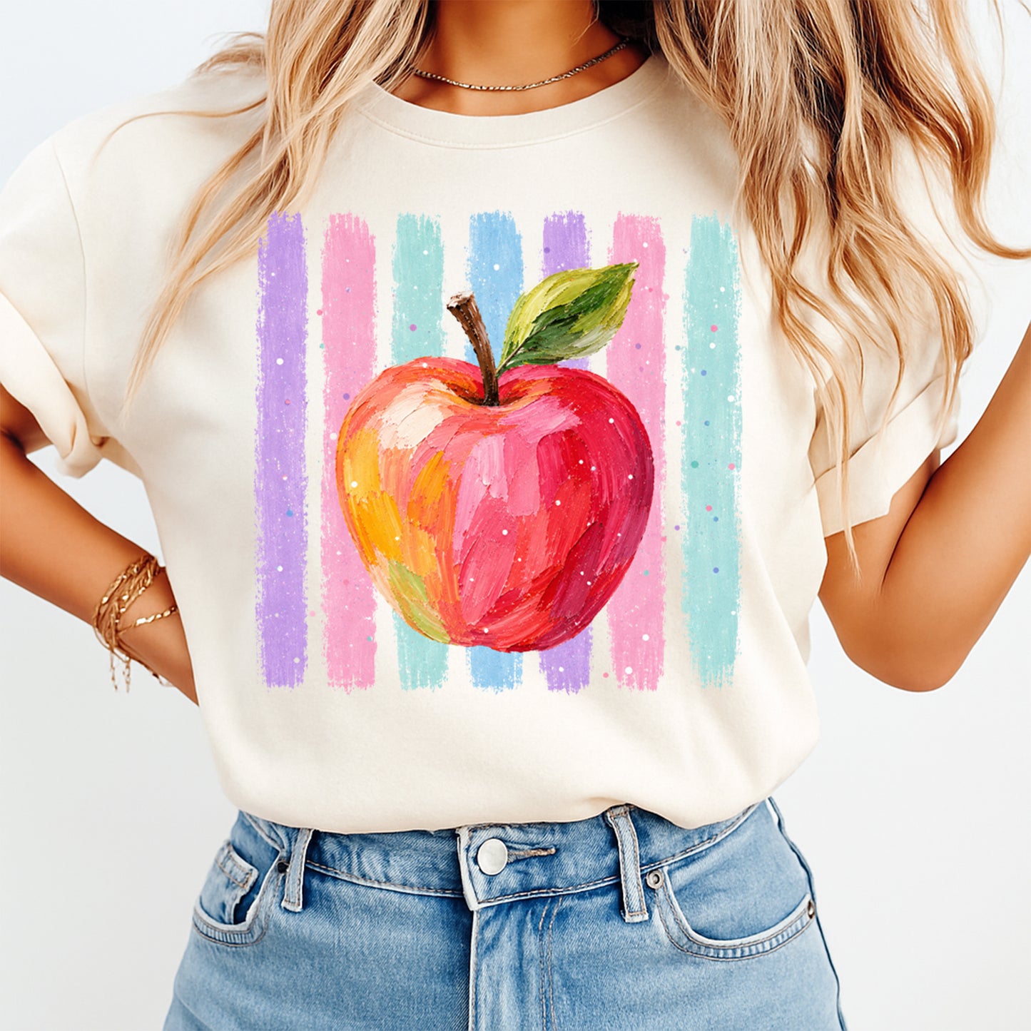 Person wearing a t-shirt with a colorful apple design on a white background