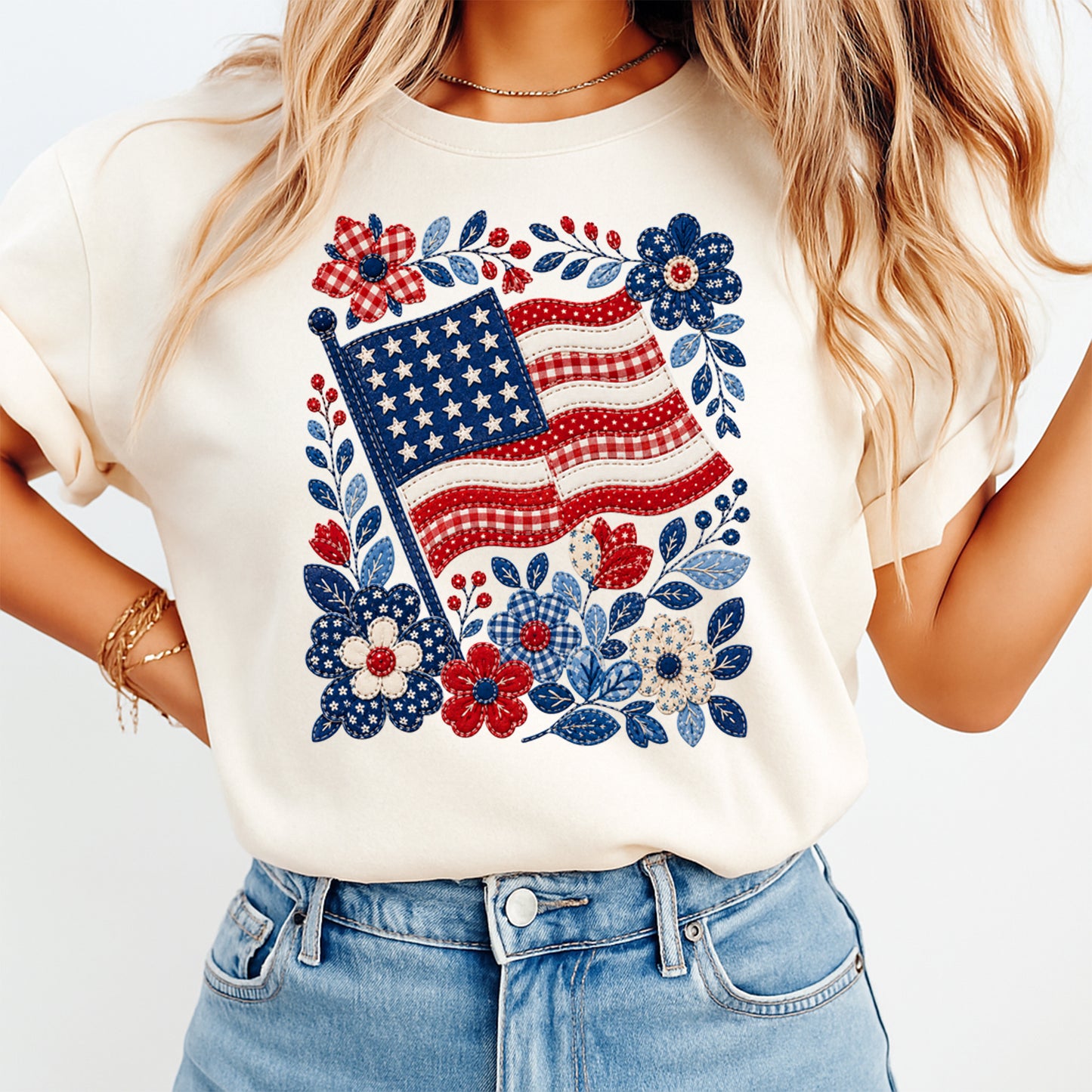 Fourth of July floral American flag DTF transfer mockup on cream shirt with stitched red white blue flag, gingham flowers, leafy accents, and patriotic Americana design.