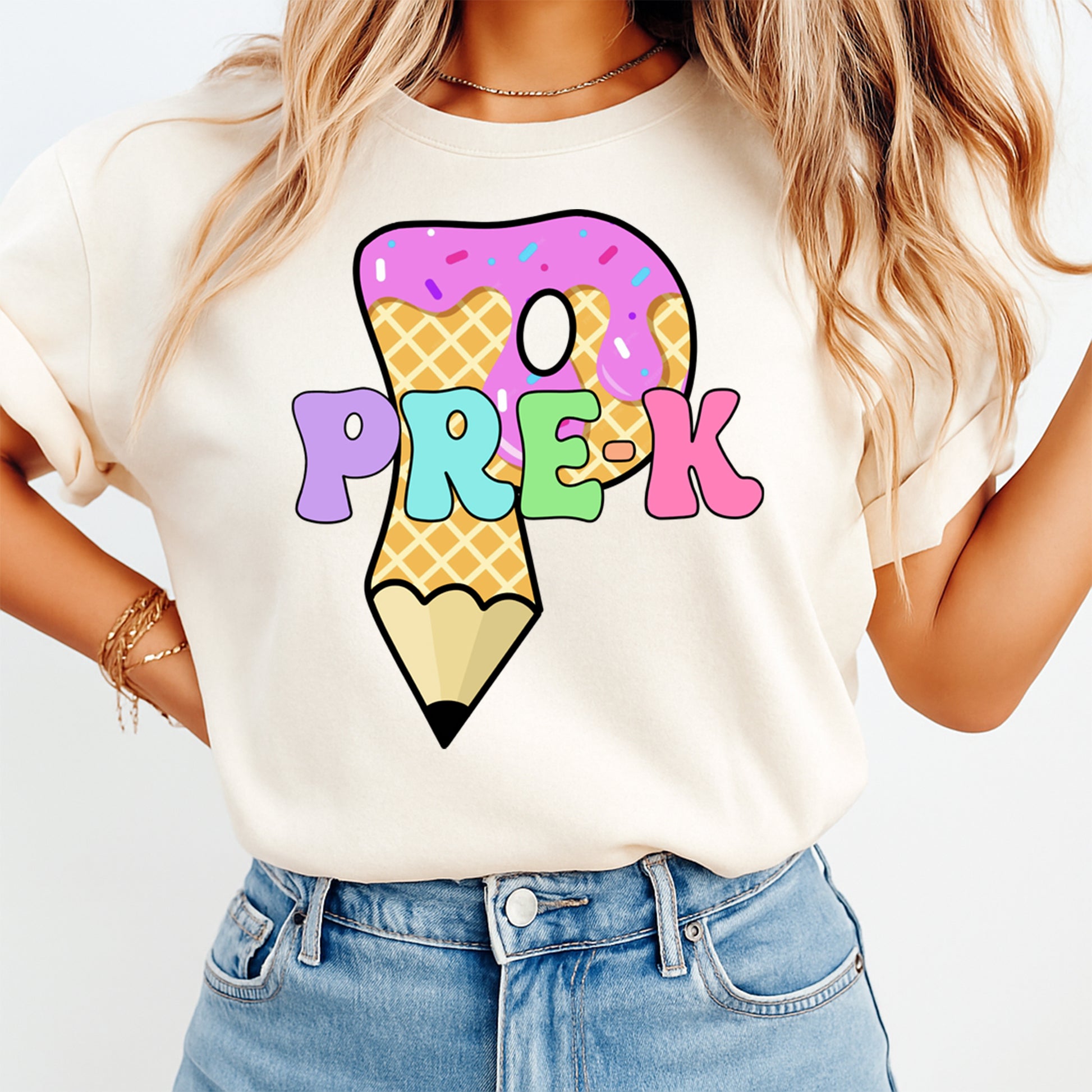 Person wearing a t-shirt with a colorful pencil and 'PRE-K' design.