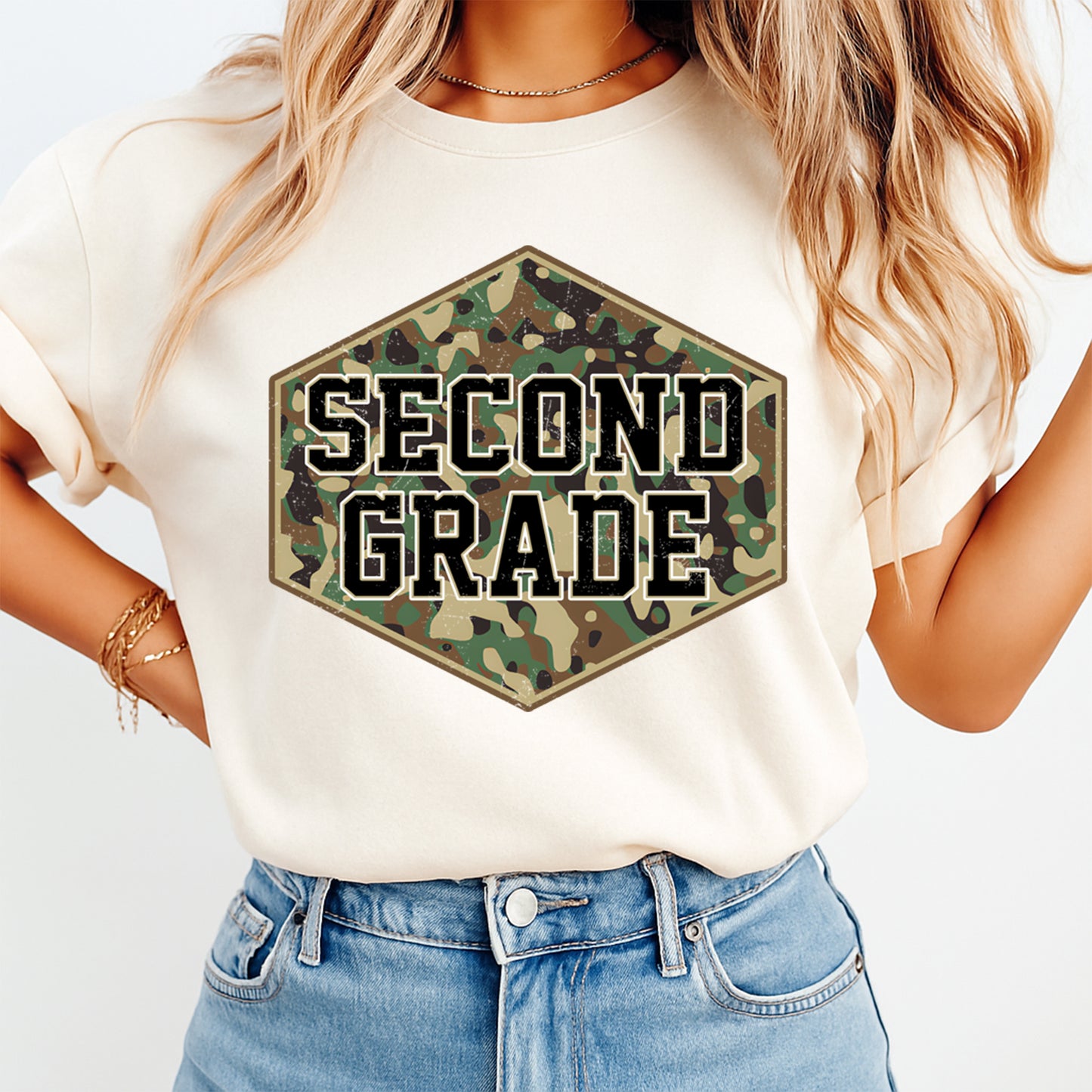 Person wearing a white t-shirt with 'SECOND GRADE' in camouflage hexagon design.