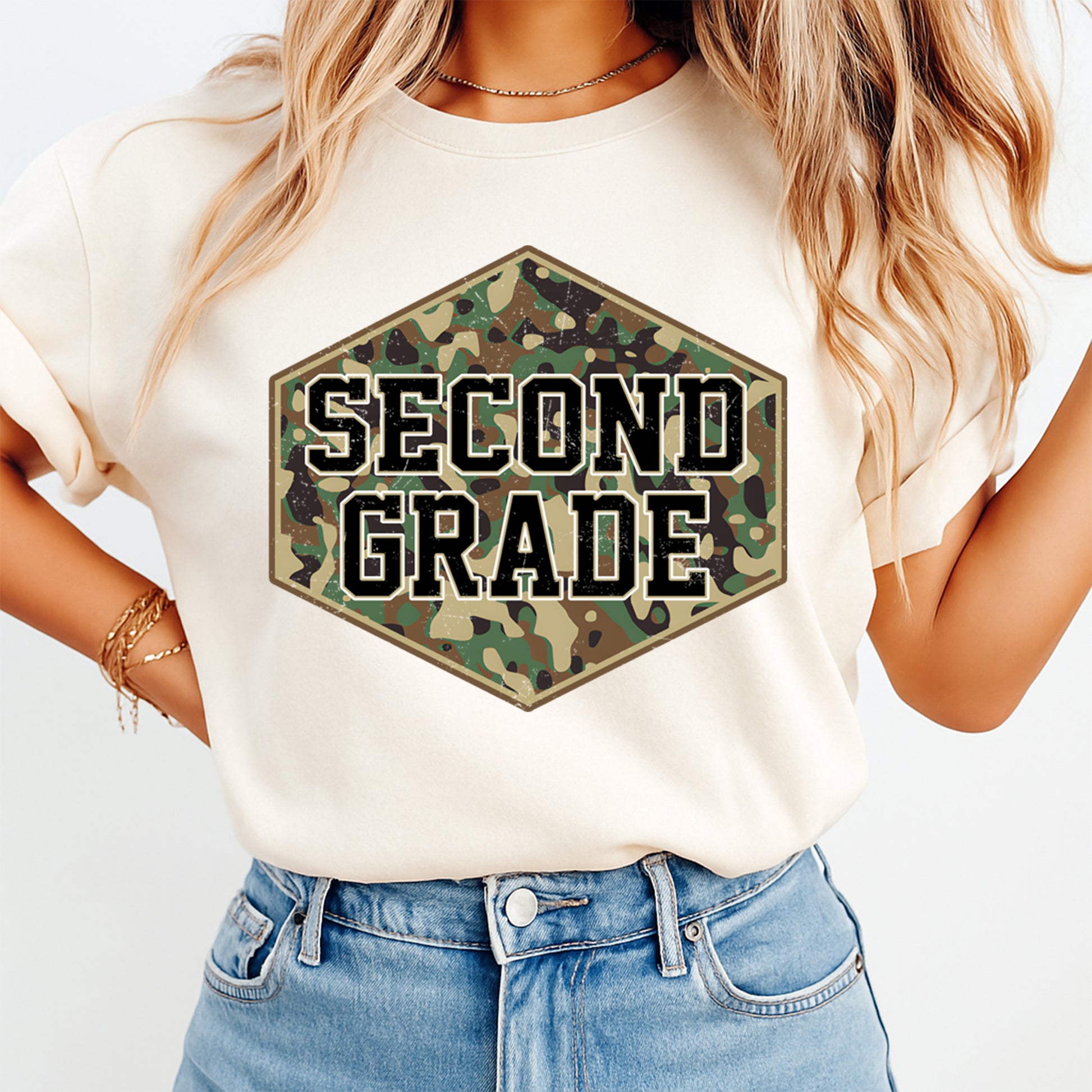 Person wearing a white t-shirt with 'SECOND GRADE' in camouflage hexagon design.