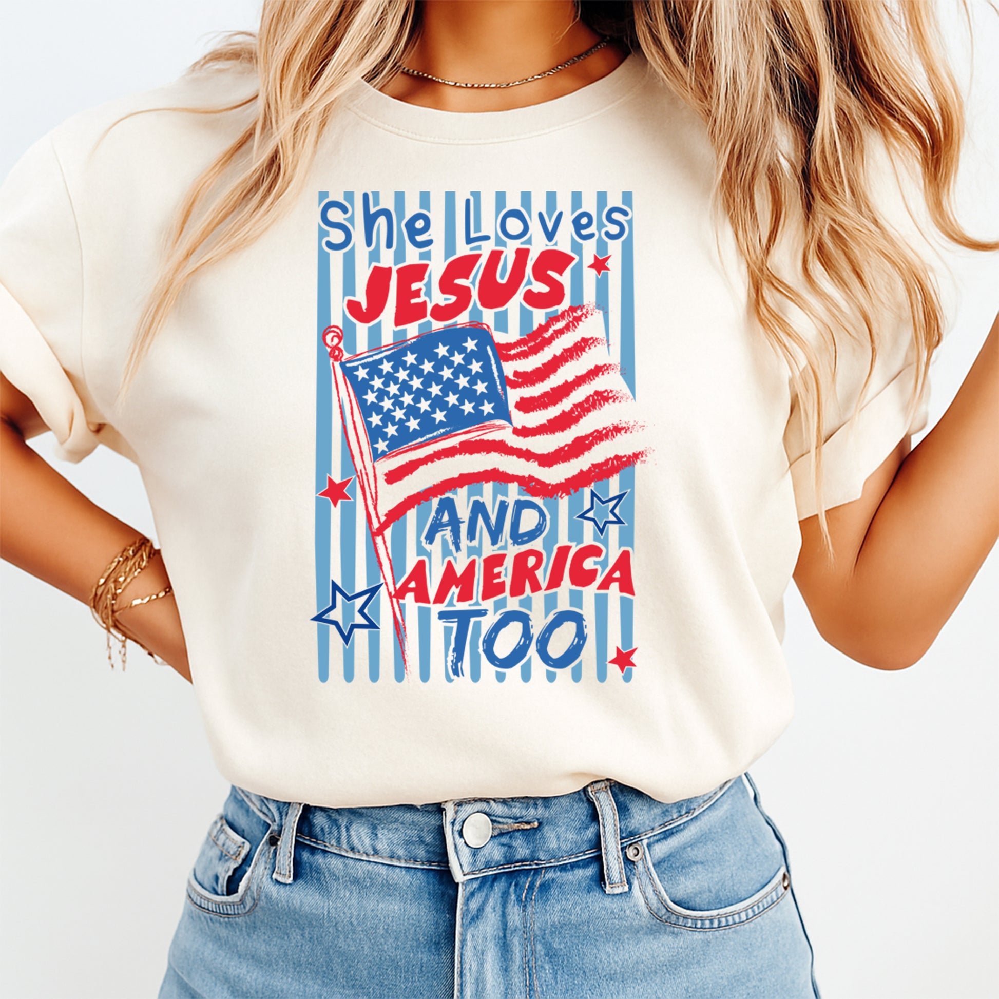 Person wearing a t-shirt with 'She Loves Jesus and America too!' text and American flag design.