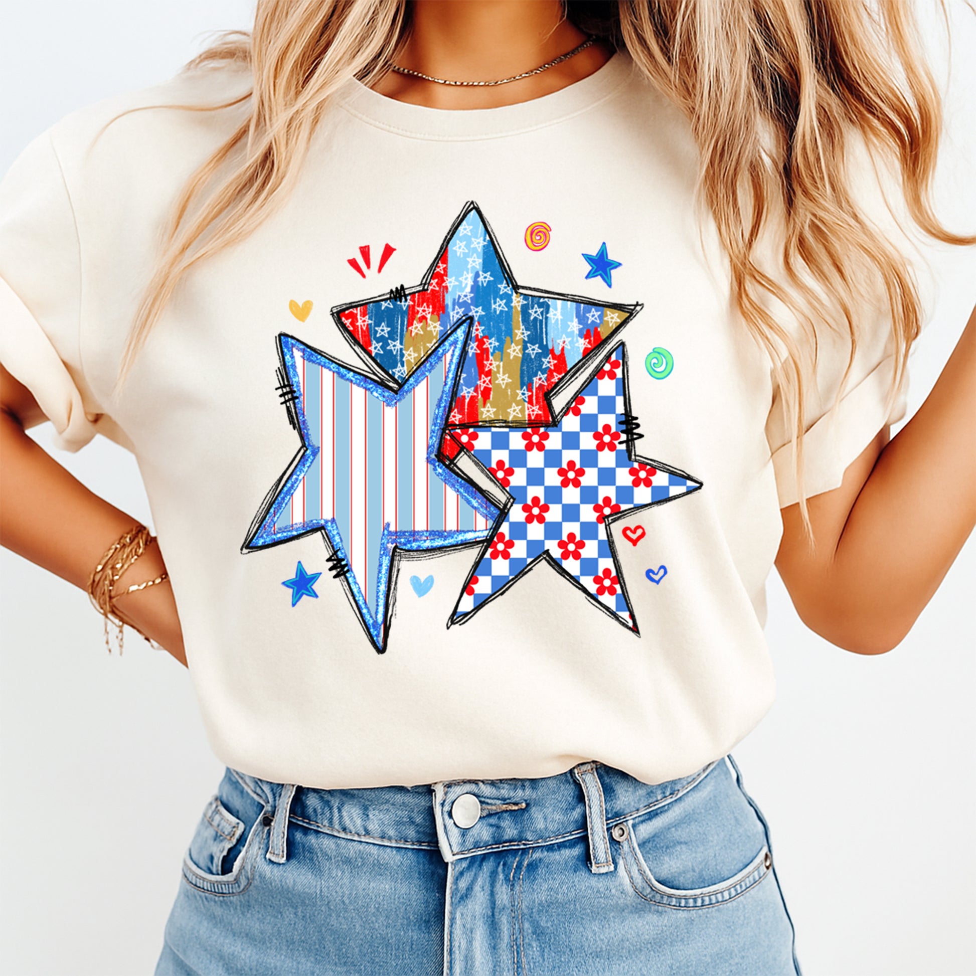 Person wearing a white t-shirt with colorful star designs on a plain background