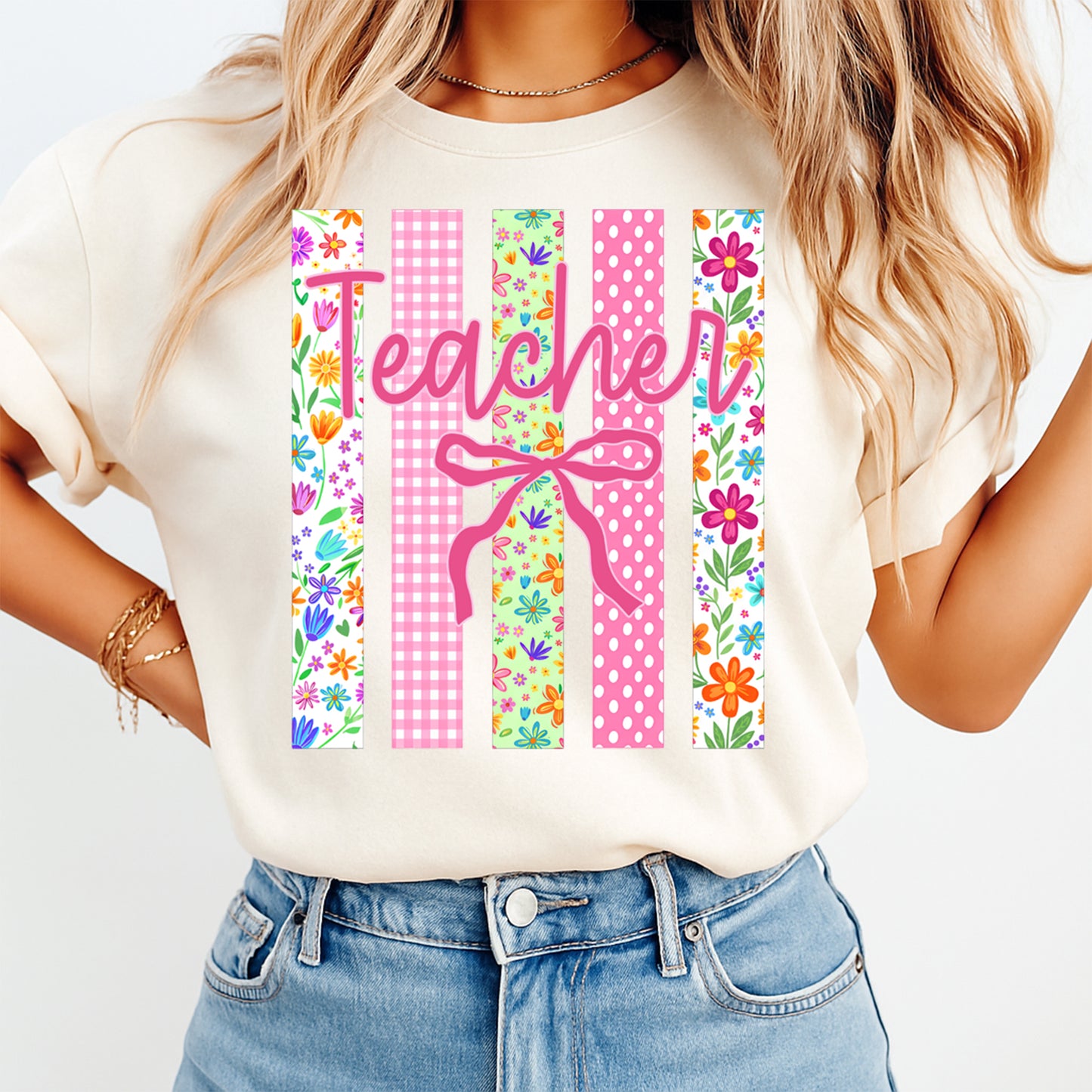 Person wearing a white t-shirt with 'Teacher' design and colorful patterns.