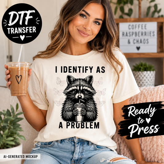 Woman wearing a t-shirt with a raccoon graphic and text, holding a coffee cup.