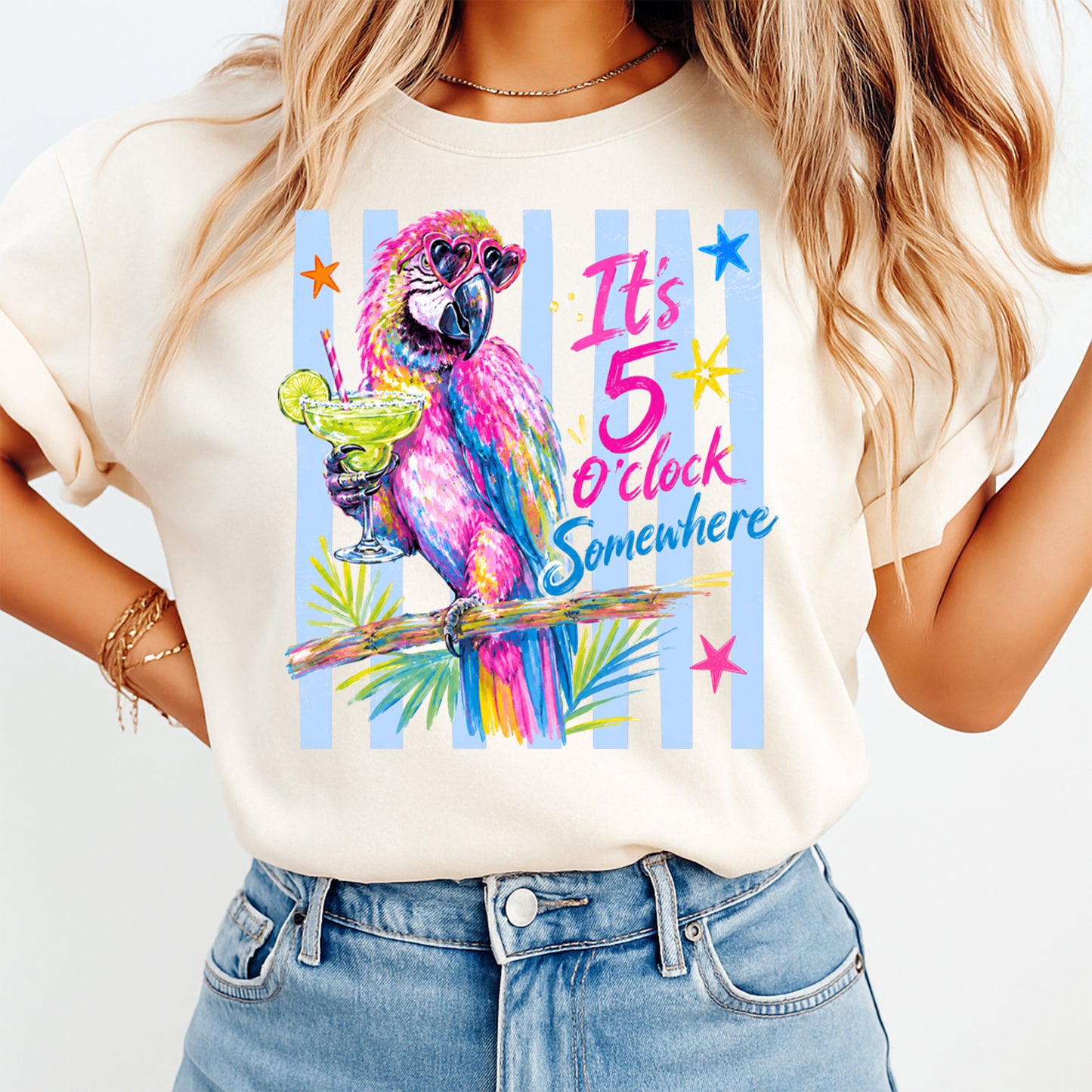 Person wearing a t-shirt with a colorful parrot design and text 'It's 5 o'clock somewhere'.