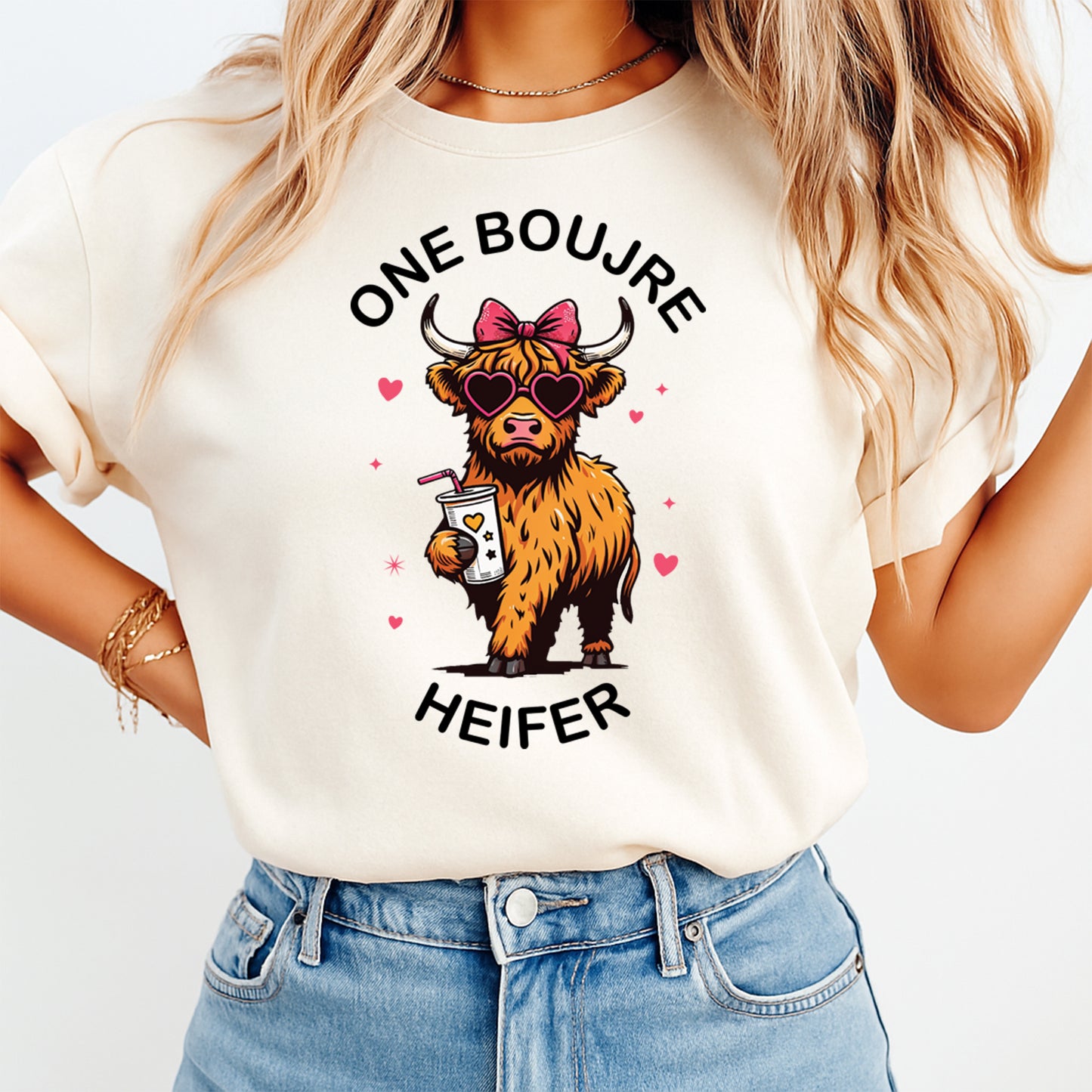 Person wearing a t-shirt with a cow graphic and text on a plain background