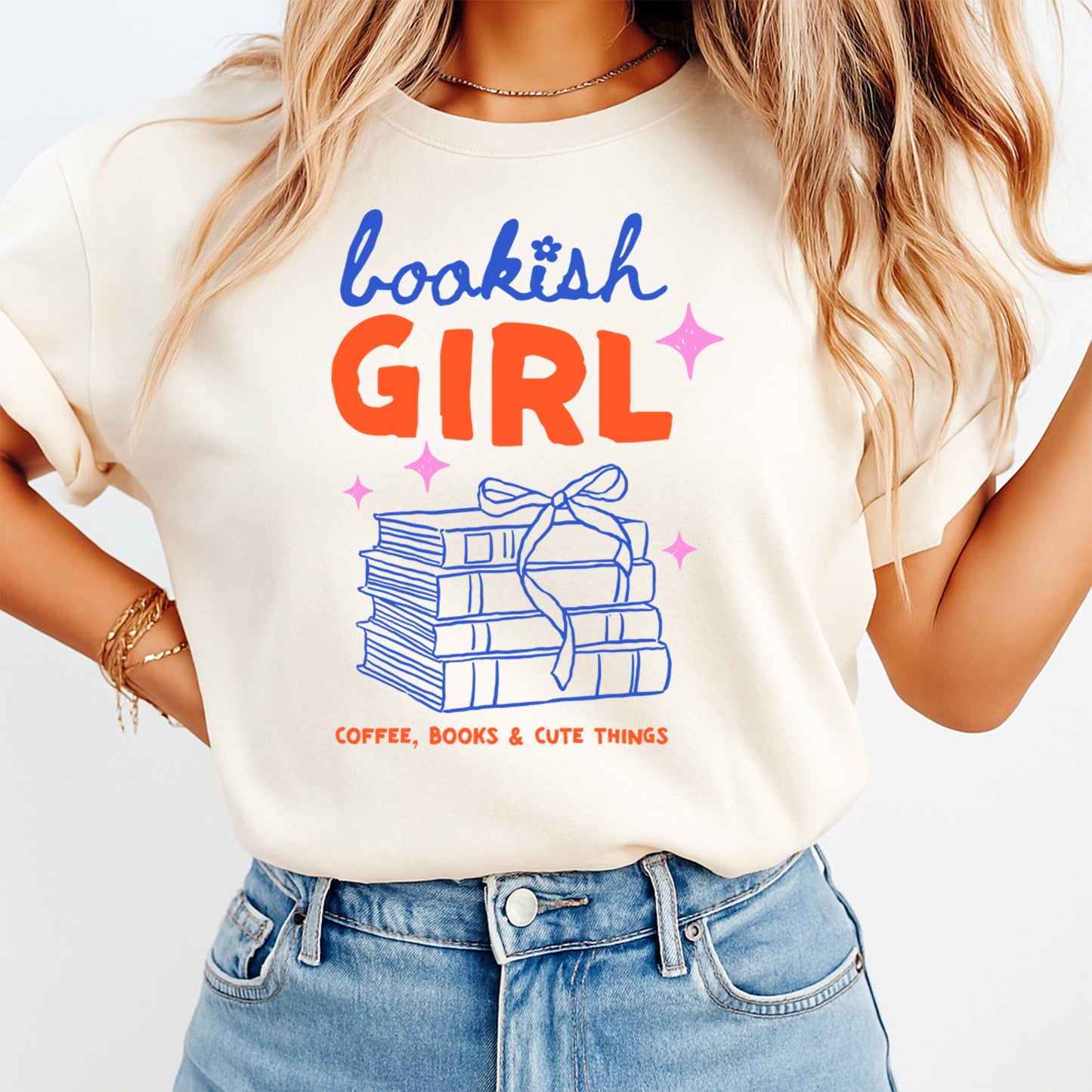 Person wearing a 'bookish GIRL' t-shirt with books and coffee graphics.