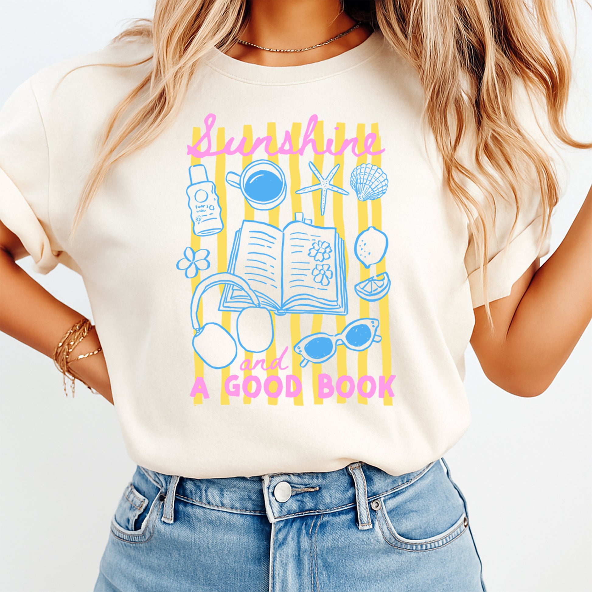 Person wearing a t-shirt with 'Sunshine and a Good Book' design on a plain background