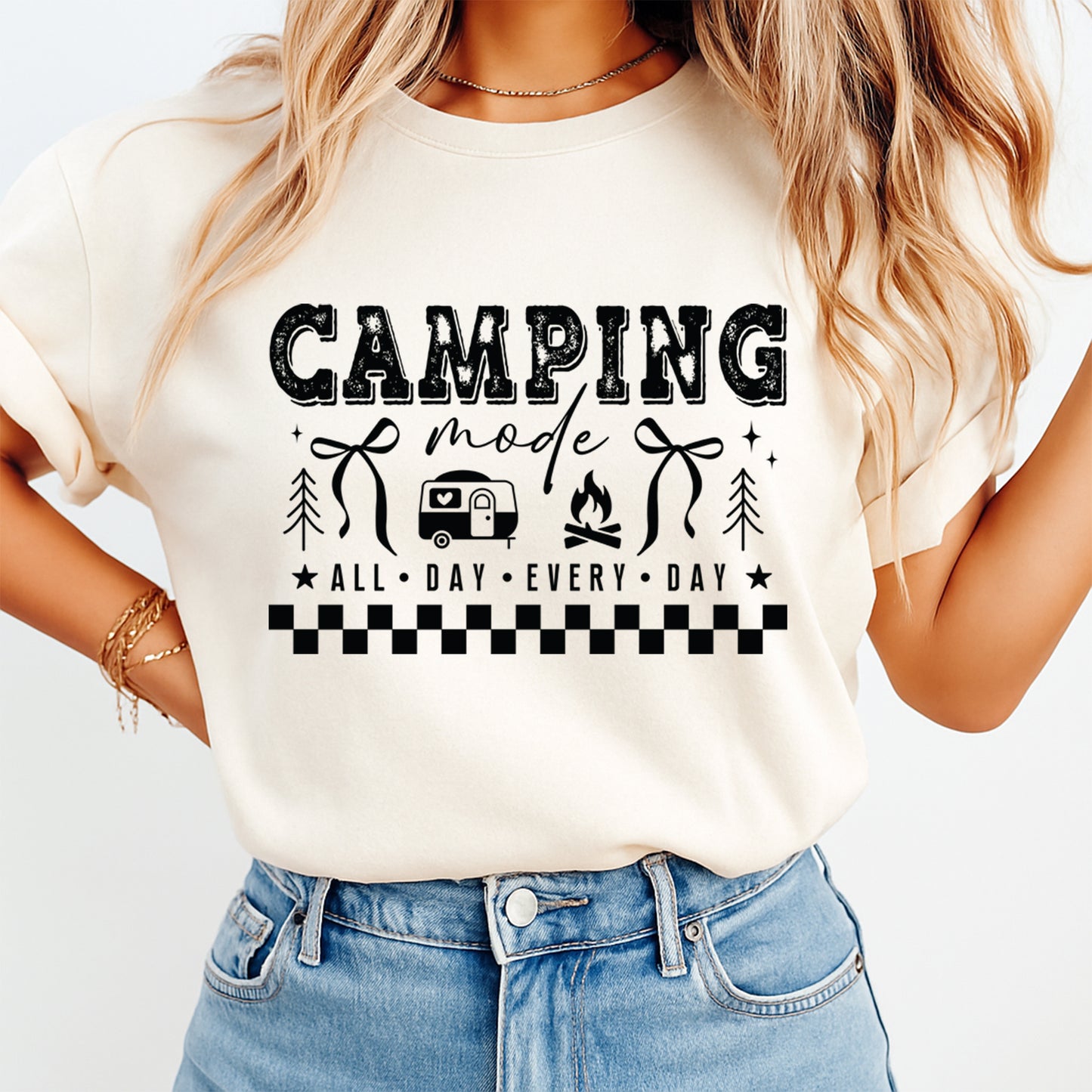 Person wearing a white t-shirt with 'Camping Mode All Day Every Day' text and graphics.