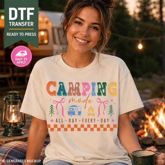 Woman wearing a t-shirt with 'Camping mode all day every day' text at a campsite.