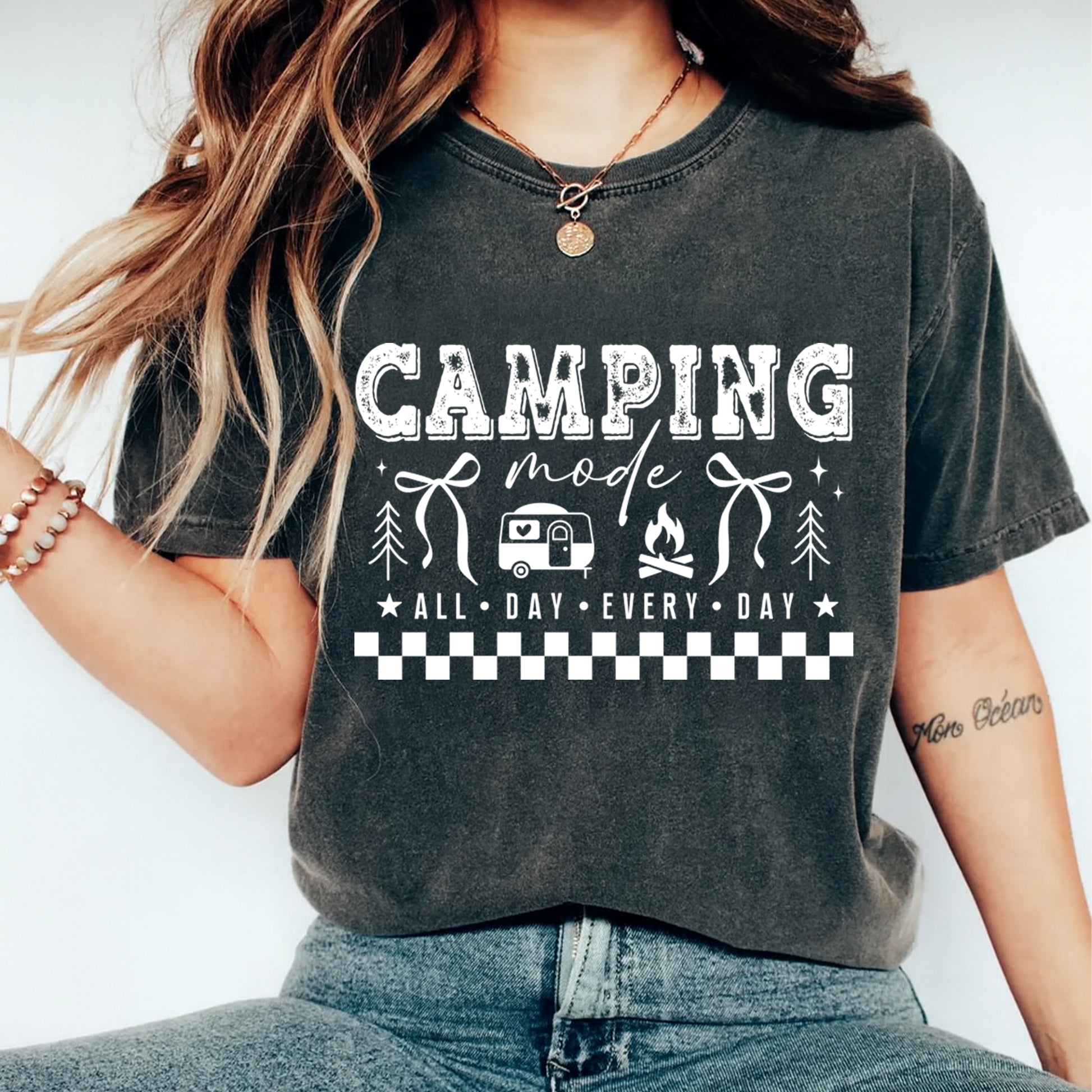 Person wearing a dark gray t-shirt with 'Camping Mode: All Day Every Day' text and graphics.