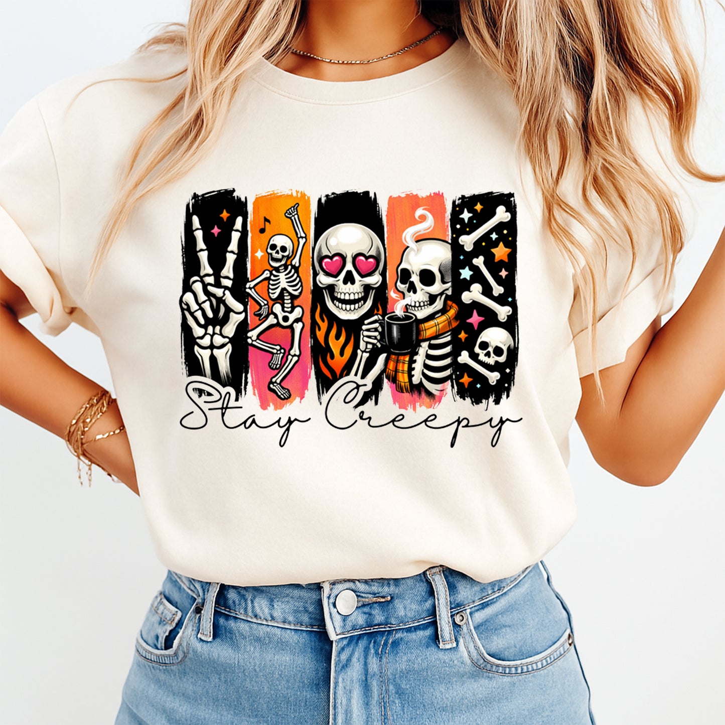 Person wearing a white t-shirt with skeleton graphics and 'Stay Creepy' text on a plain background