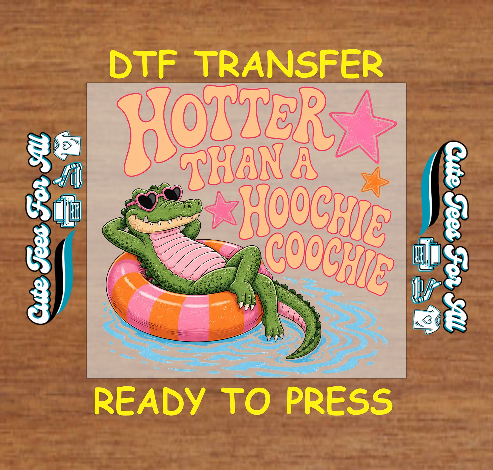 DTF transfer with a cartoon alligator on an inner tube and text 'Hotter than a Hoochie Coochie' on a wooden background.