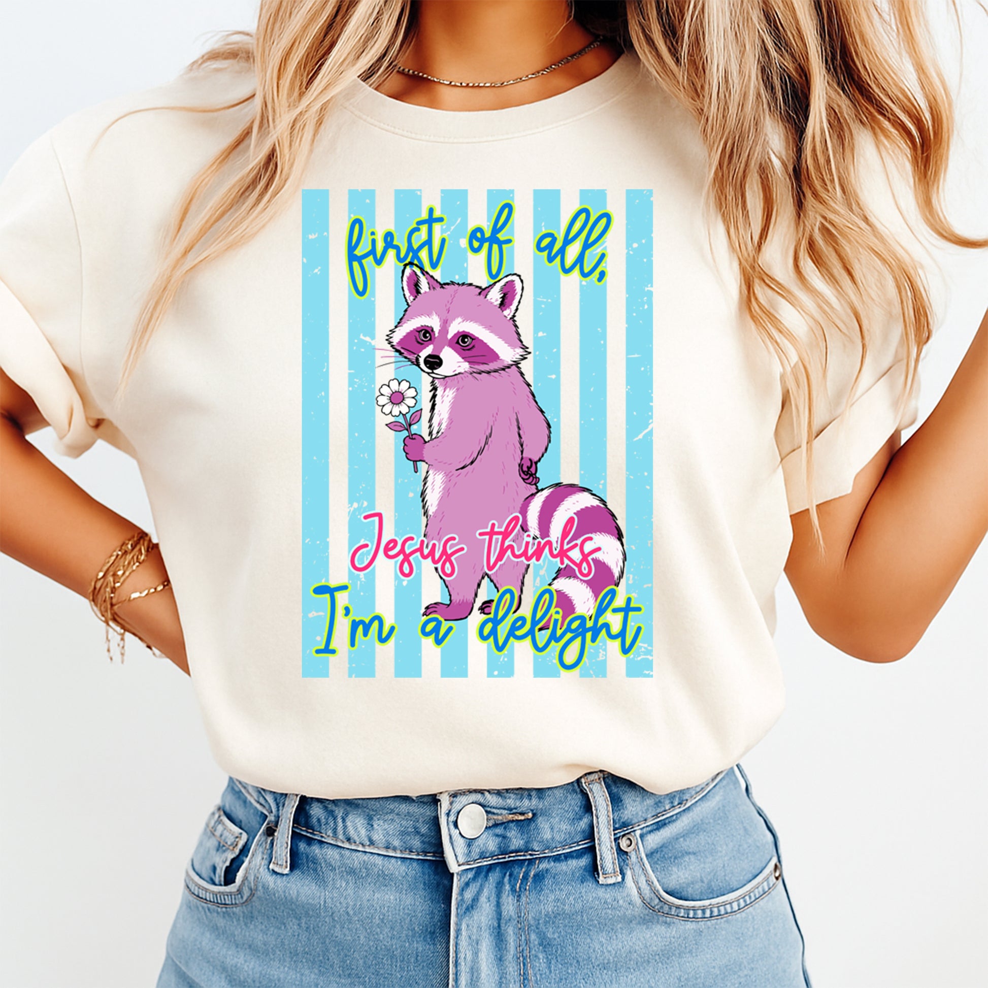 Person wearing a t-shirt with a cartoon raccoon design and text on a white background
