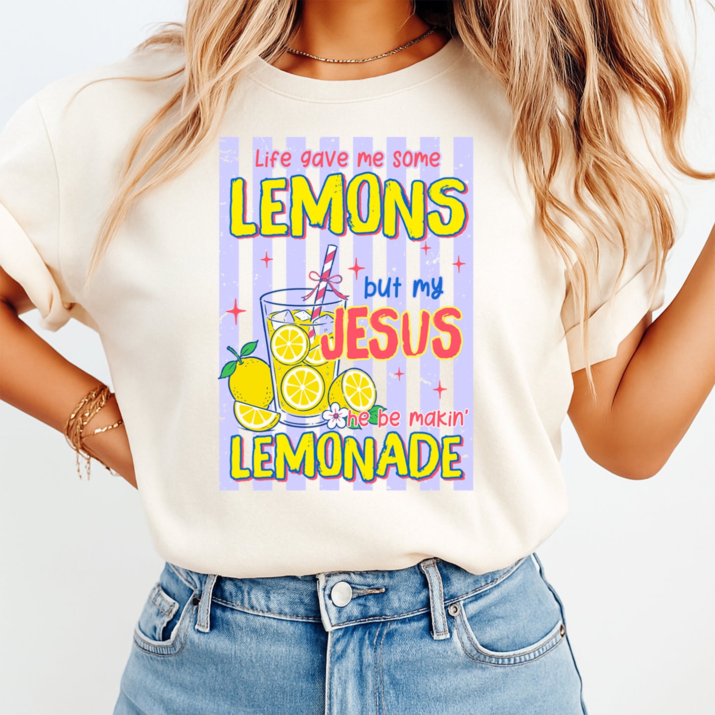 Person wearing a white t-shirt with a colorful graphic and text.