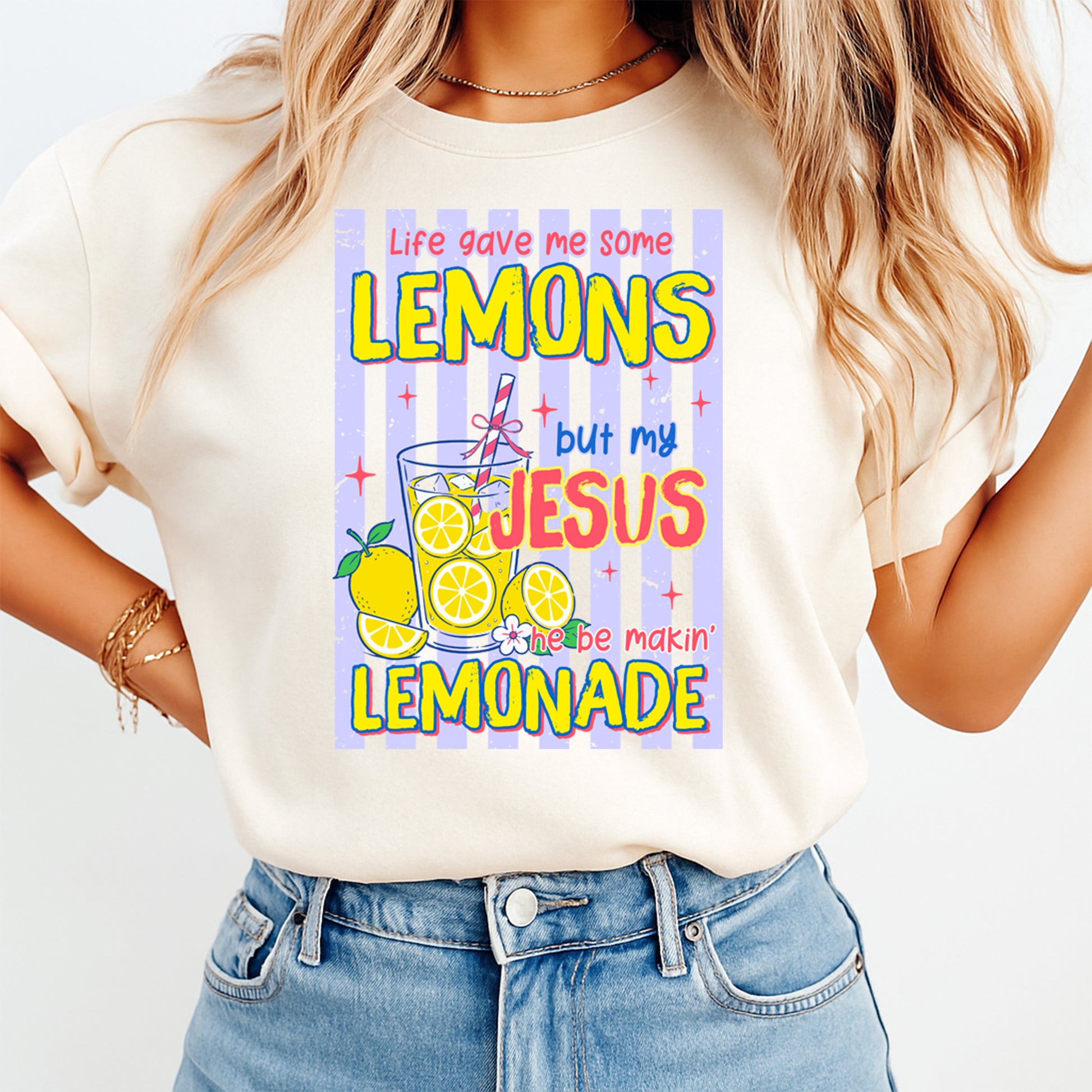 Person wearing a white t-shirt with a colorful graphic and text.