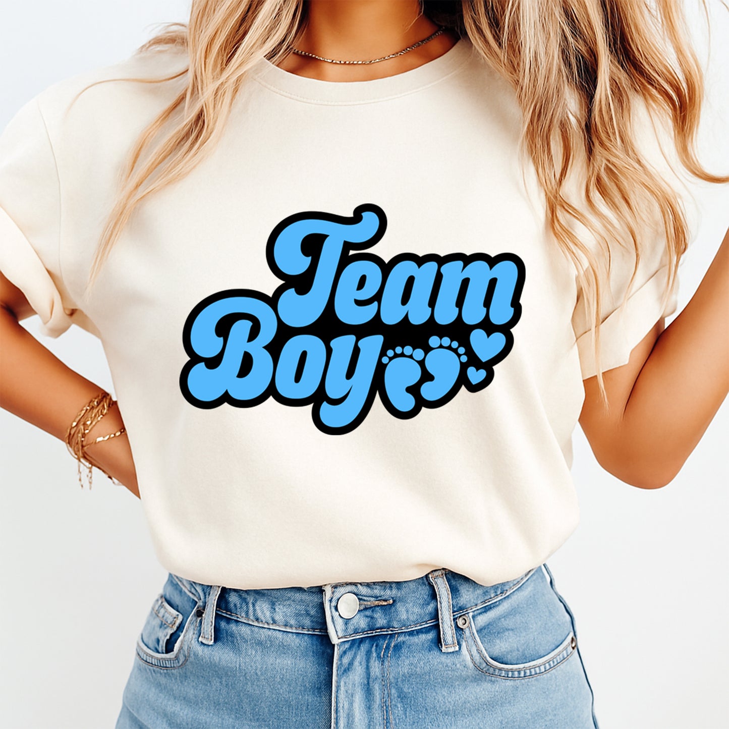 Person wearing a white t-shirt with 'Team Boy' text in blue on a plain background